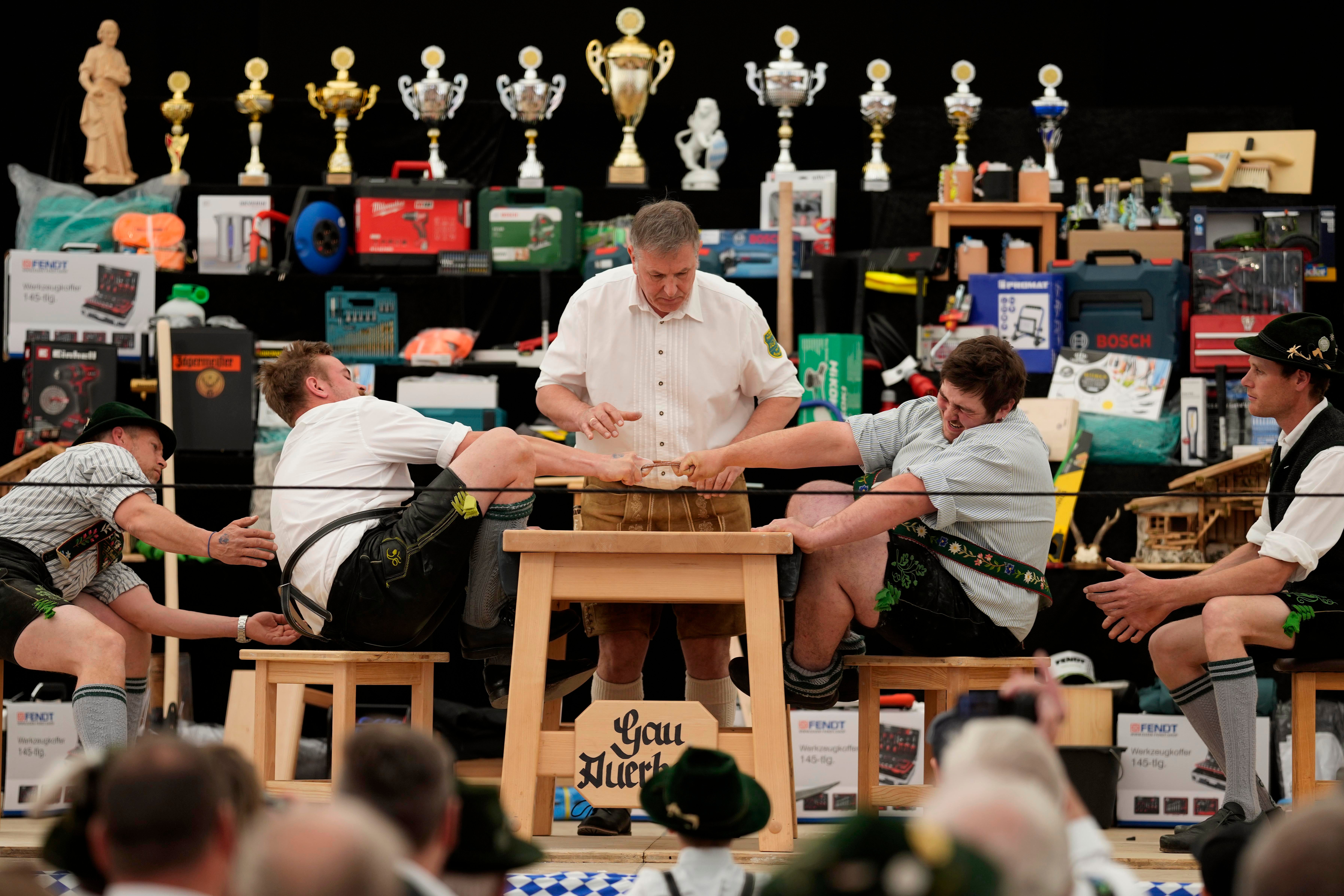 Germany Finger A referee monitors the leather ring held by two competitors with their middle fingers at the German finger strength Championships