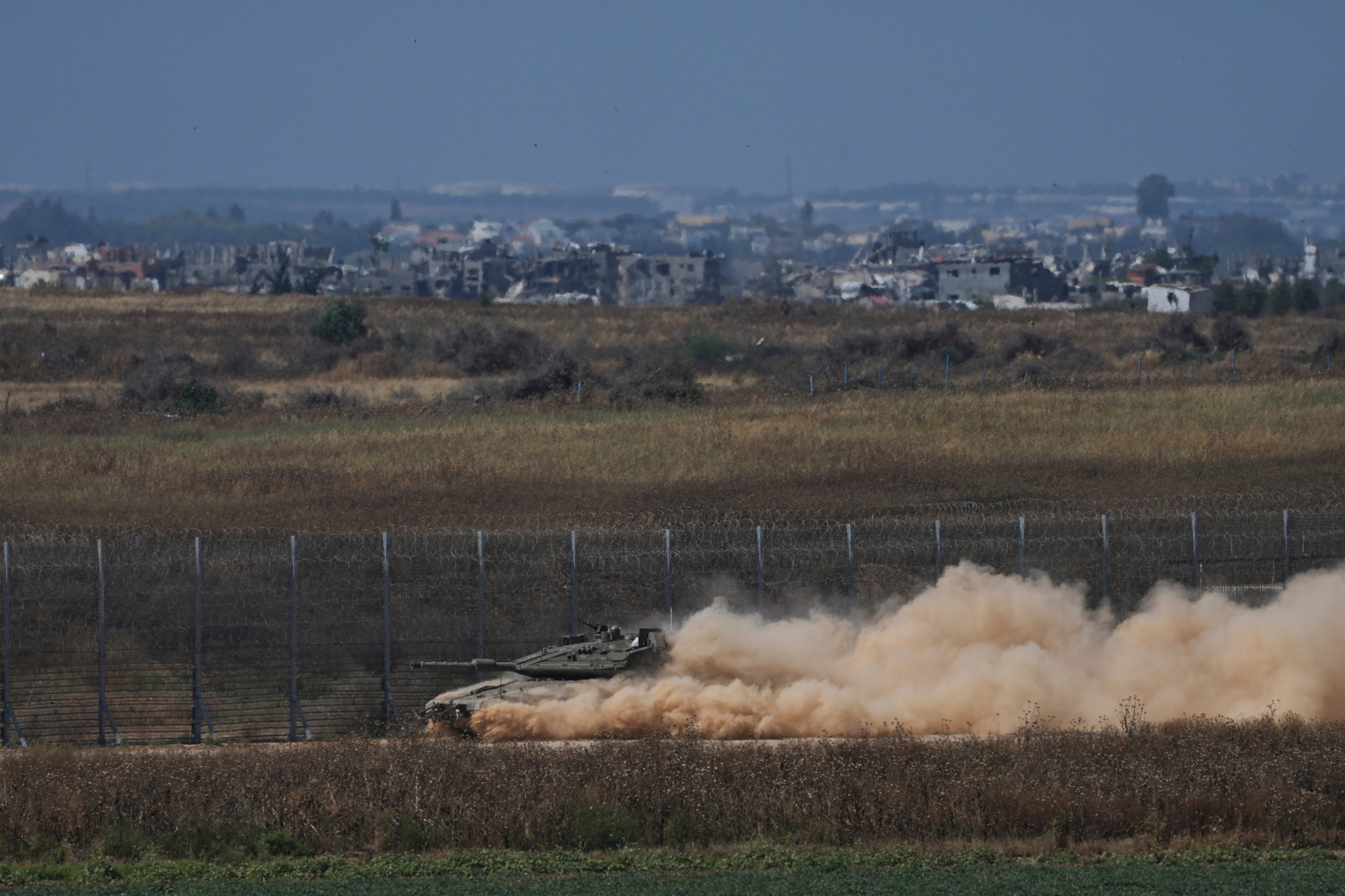 An Israeli tank moves near the Israeli-Gaza border, as seen from southern Israel