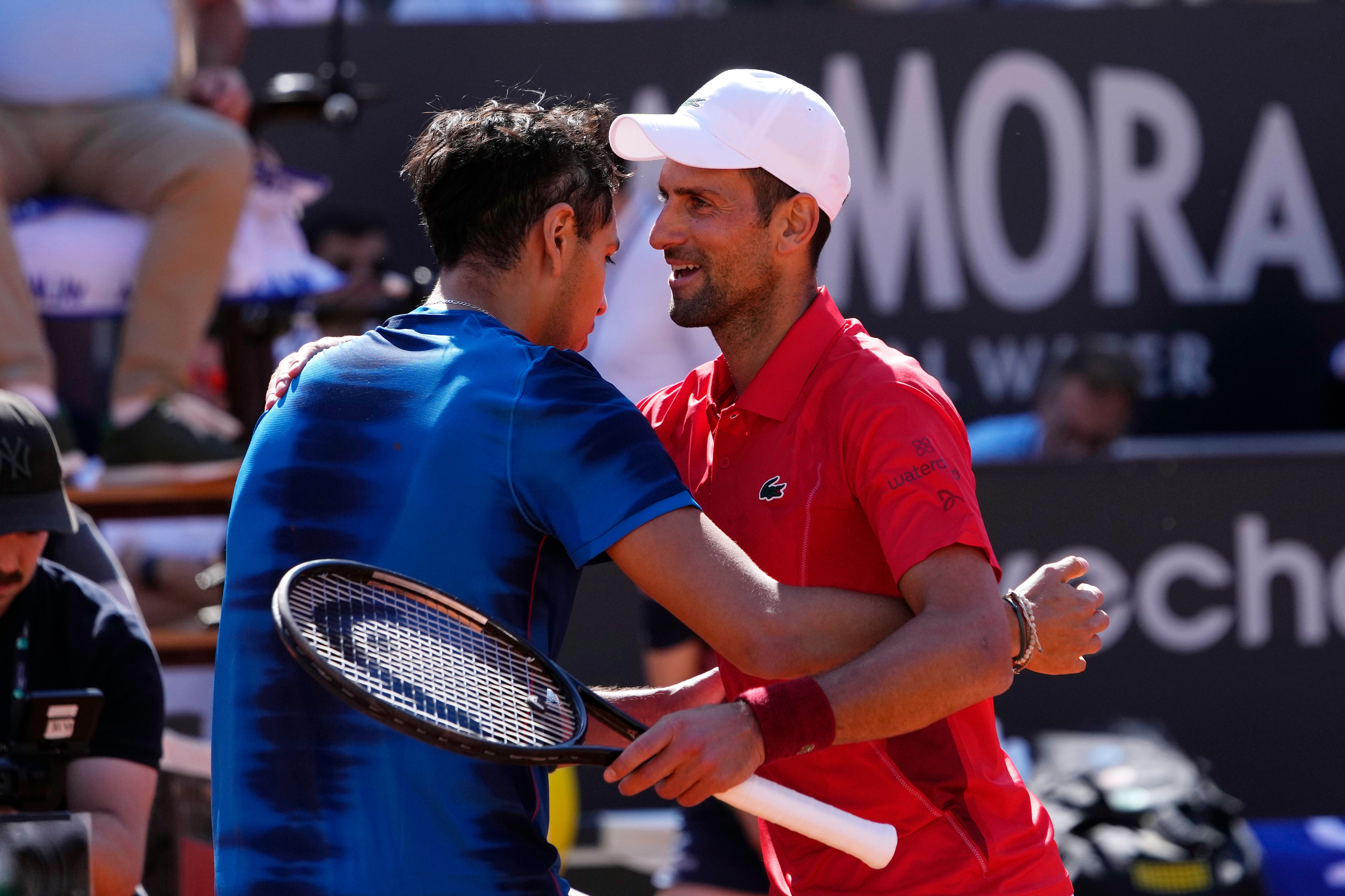 Serbia’s Novak Djokovic (right) hugs Chile’s Alejandro Tabilo after their match at the Italian Open (Alessandra Tarantino/AP)