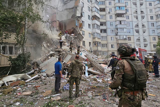 <p>Emergency service workers inspect the site of a damaged apartment block in Belgorod, a Russian region on the border with Ukraine </p>