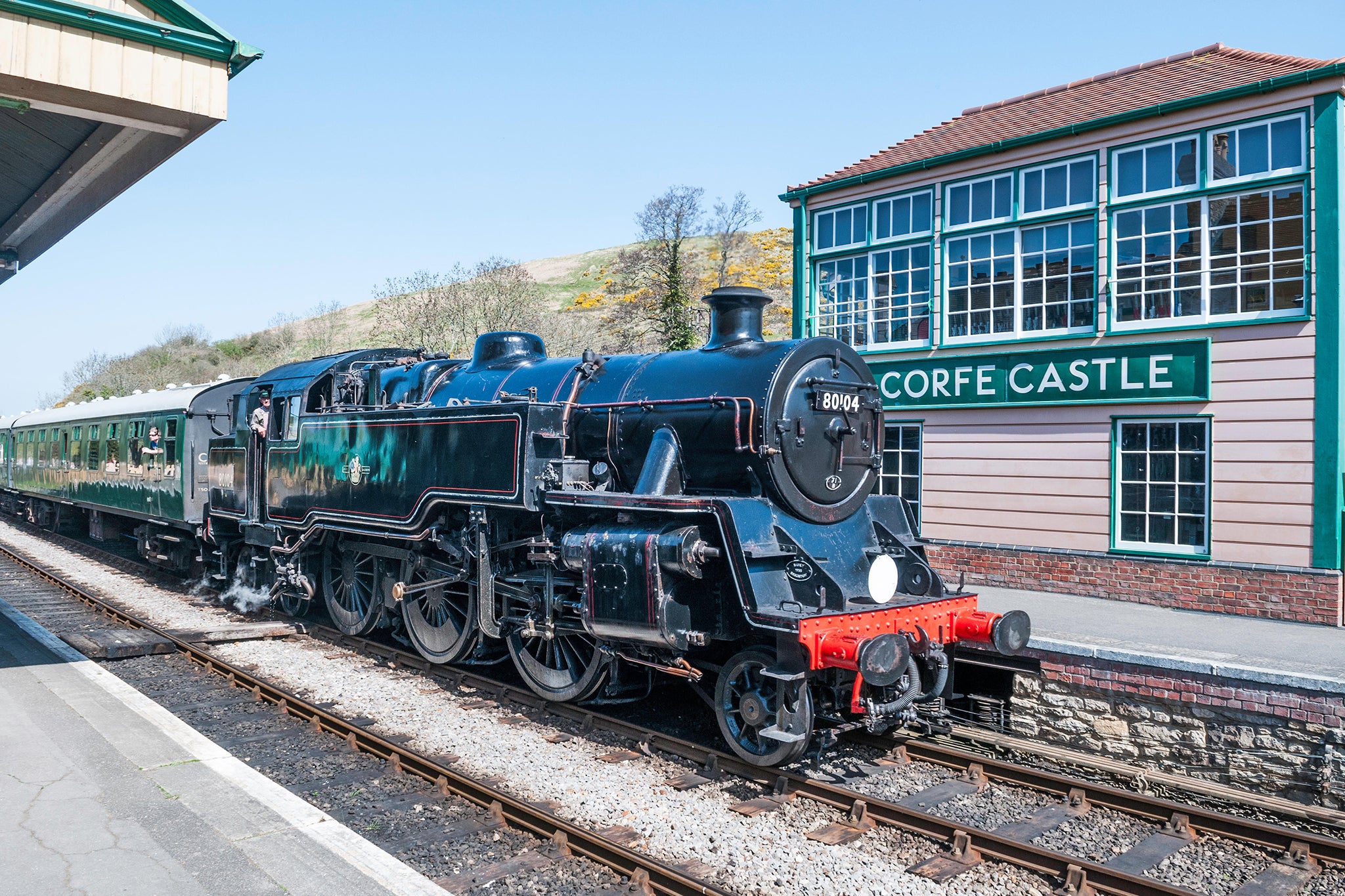 A steam locomotive on the Swanage Railway heritage line at Corfe Castle station in Dorset