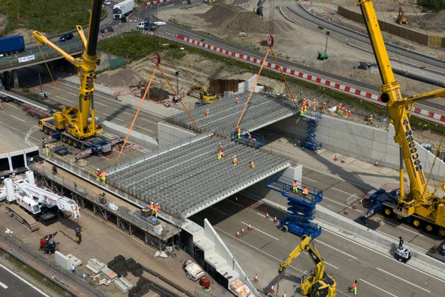 <p>Engineering works taking place at the A3 Wisley interchange at Junction 10 of the M25 as concrete beams for a new bridge are installed (Jordan Pettitt/PA)</p>