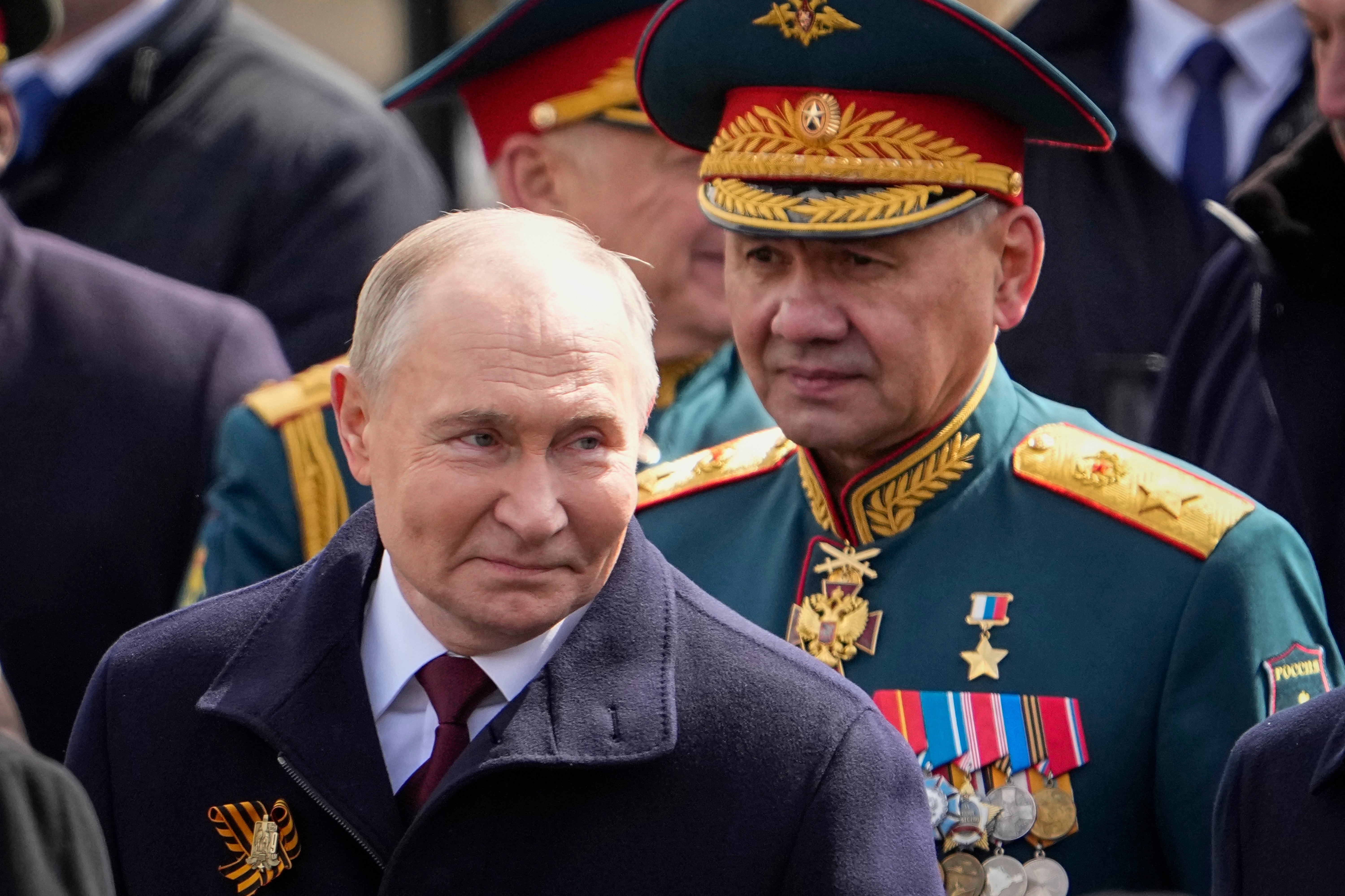 Russian President Vladimir Putin has proposed removing Russian Defense Minister Sergei Shoigu (right) from his post