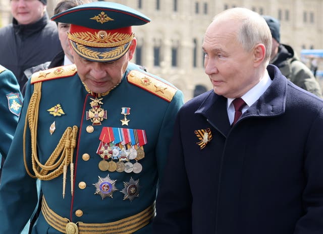 <p>Russian president Vladimir Putin and Sergei Shoigu, who is set to be replaced as defence minister in a surprise reshuffle announced by the Kremlin</p>