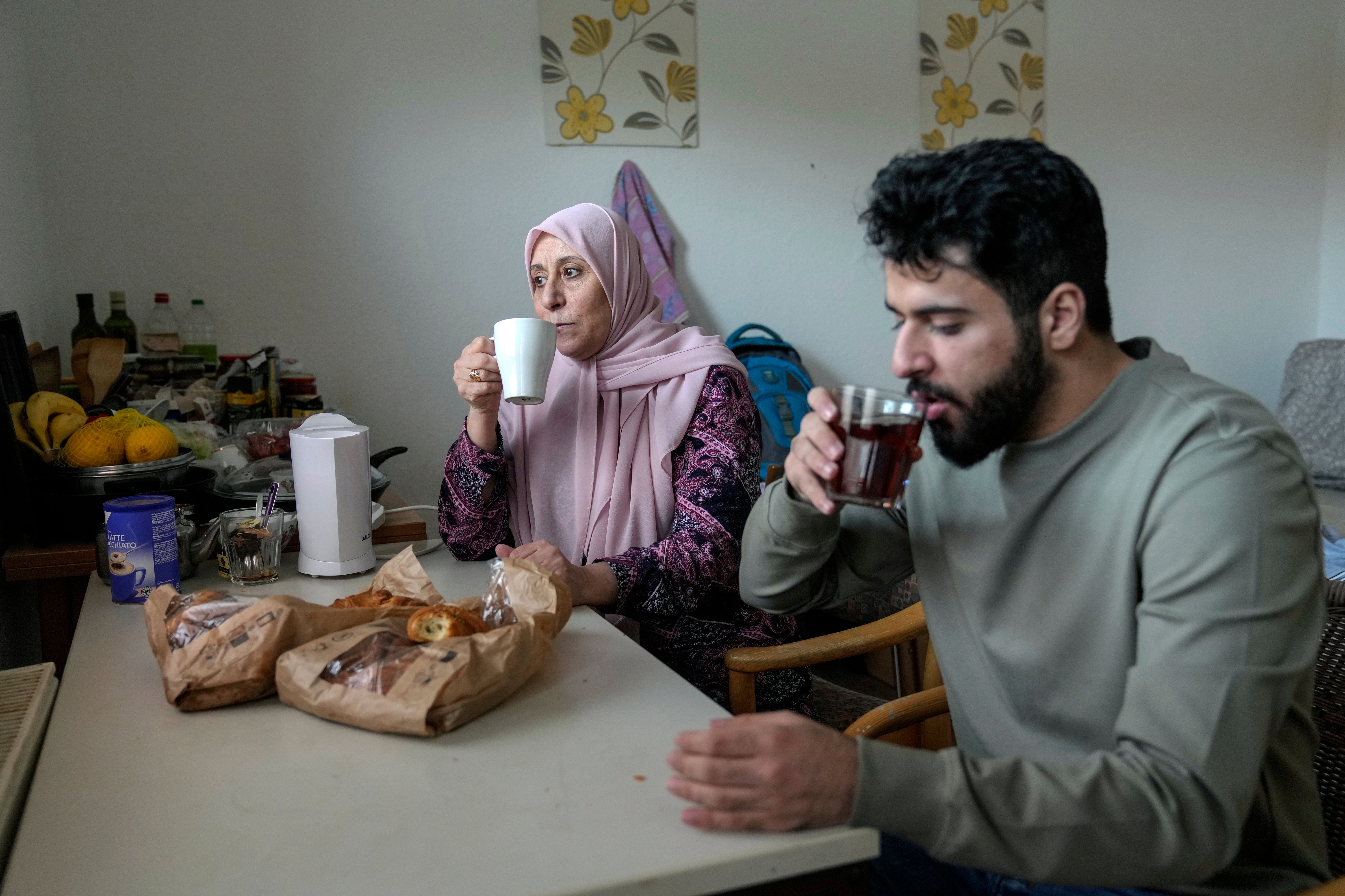 Palestinian asylum seekers Jihad Ammuri 20-year-old and his mother amileh Saqer 68-year-old, drink tea in a refugee shelter in Germany