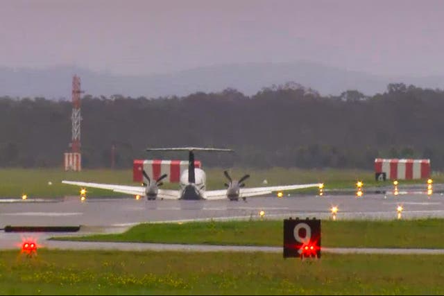 <p>In this image taken from video, a light plane with three people aboard lands safely without landing gear at Newcastle Airport, Australia</p>