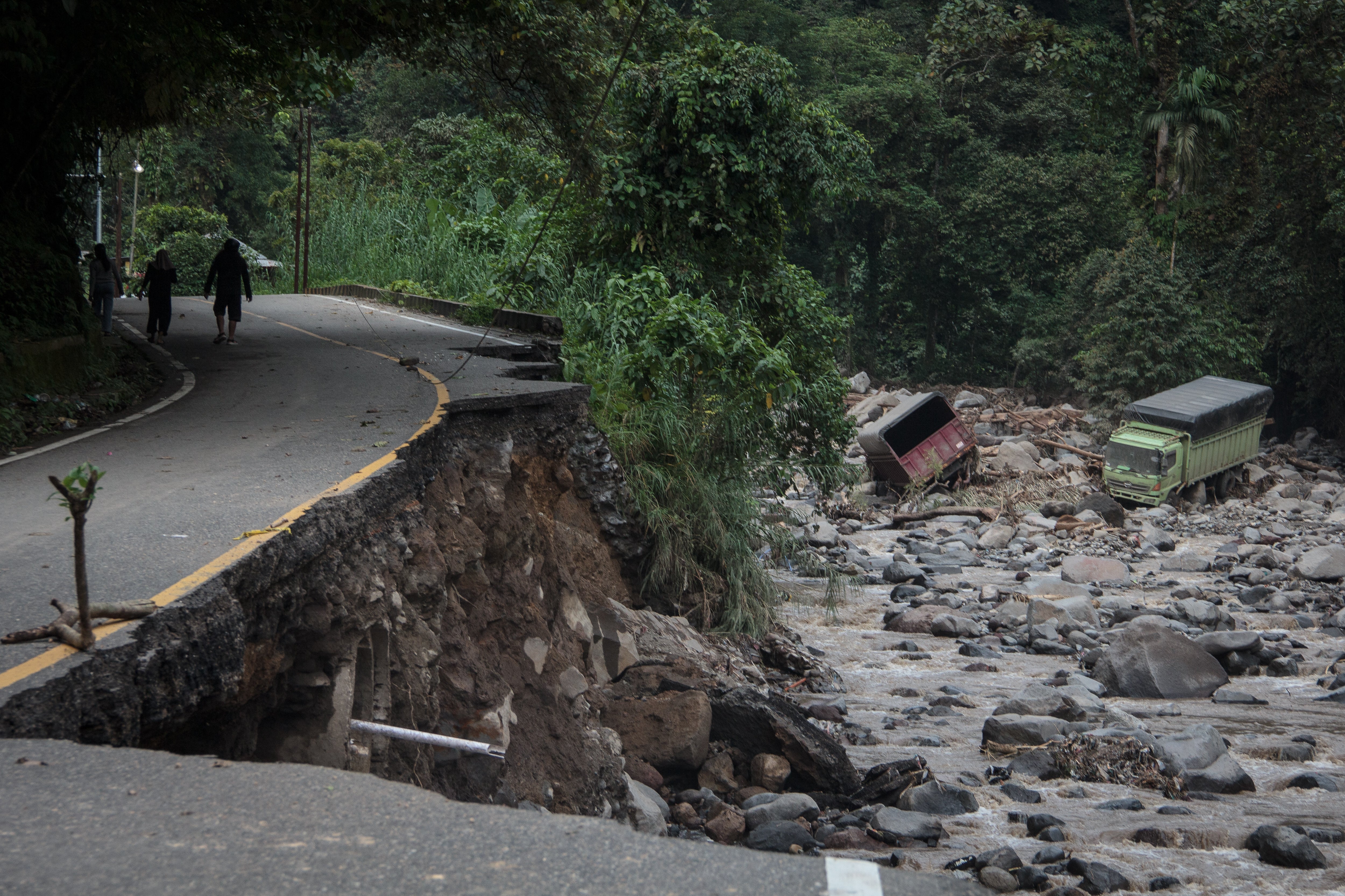 <p>A damaged road is seen after flash floods and cold lava flow from a volcano in Tanah Datar, West Sumatra</p>