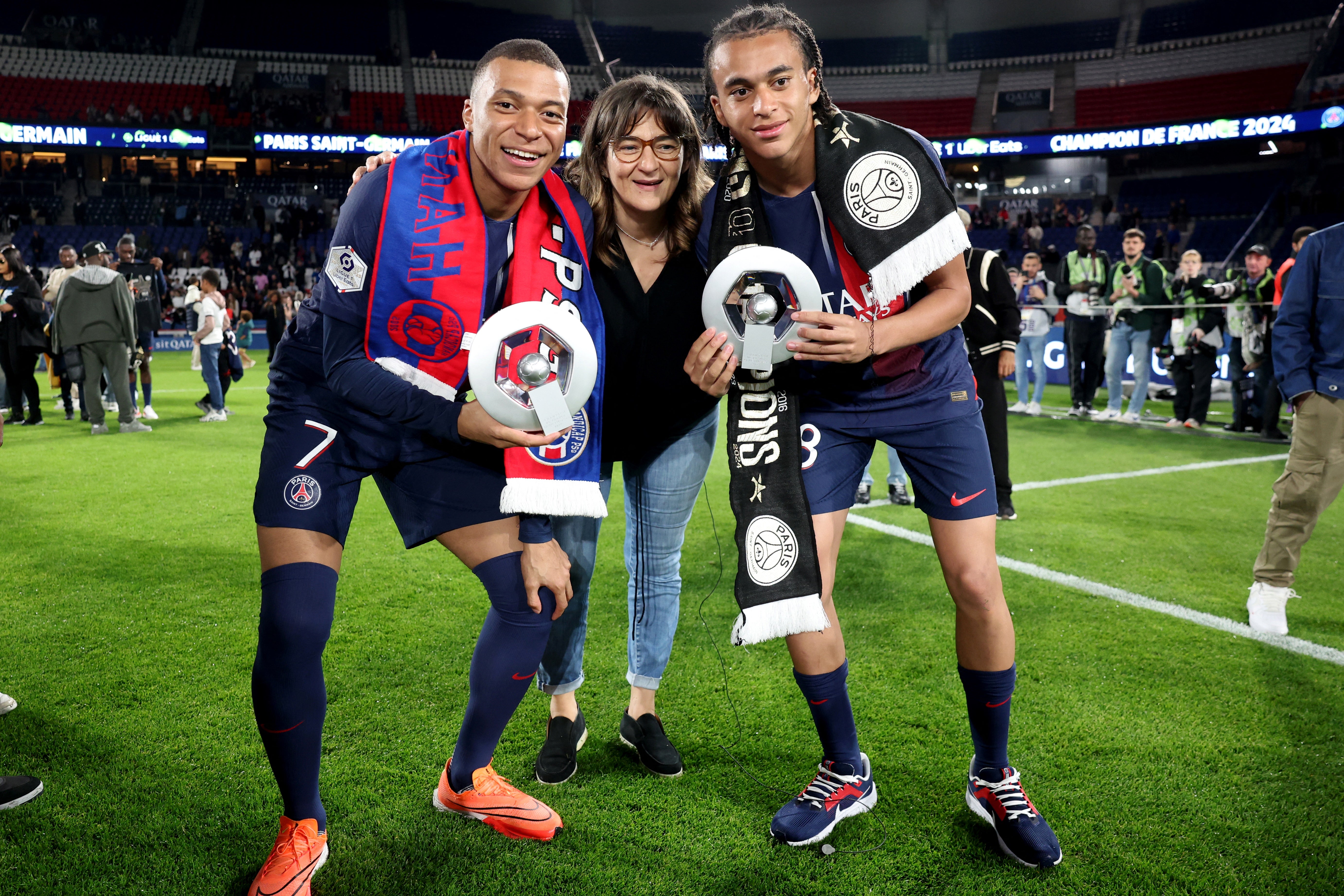 Mbappe and his brother Ethan, who also plays for PSG, pose with their mother after winning the Ligue 1 title this season.