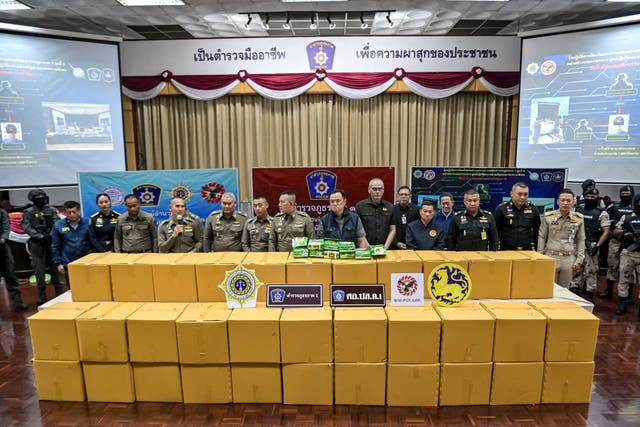 <p>Acting Thai National Police Chief Kittharath Punpetch (centre L) and Deputy Prime Minister Anutin Charnvirakul (centre R) stand alongside other officials in front of boxes of crystal methamphetamine</p>