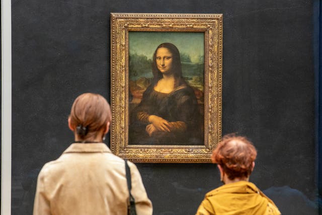 <p> Visitors observe the painting The Mona Lisa by  Leonardo Da Vinci on display in a gallery at Louvre</p>