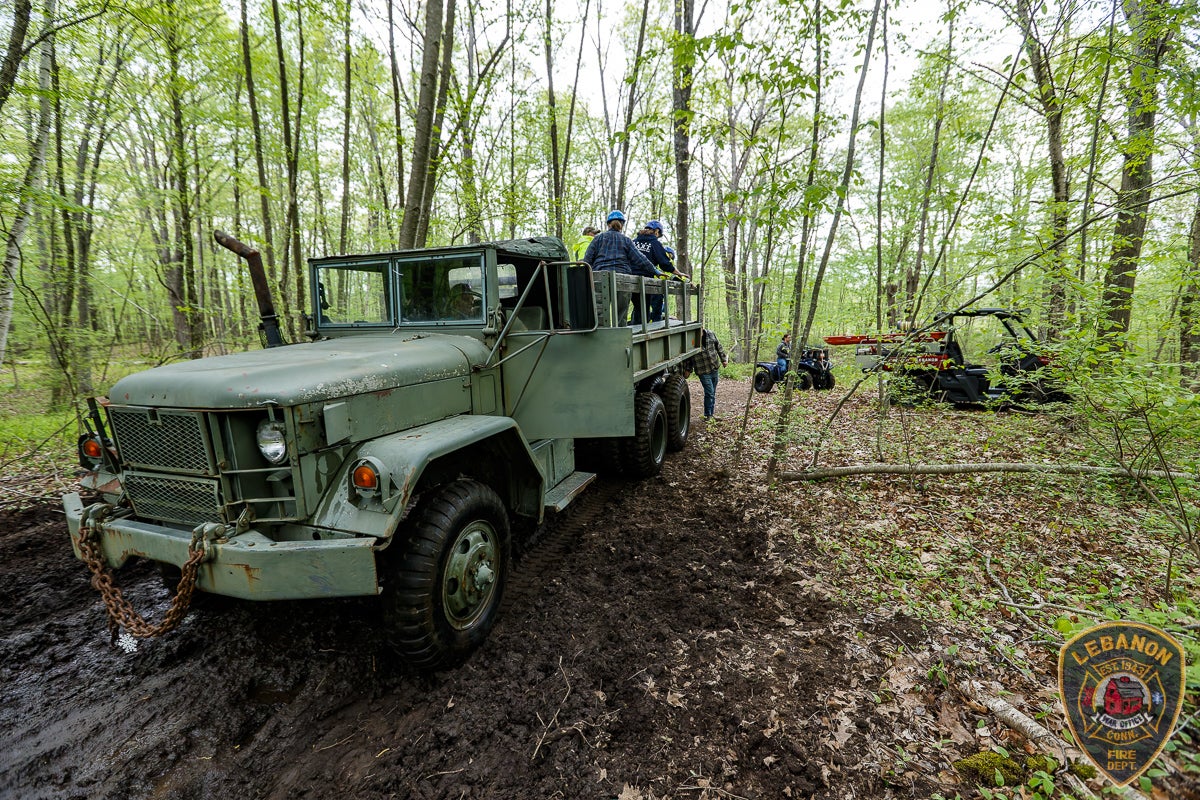 A cargo vehicle was used to ferry across equipment into the muddy woods