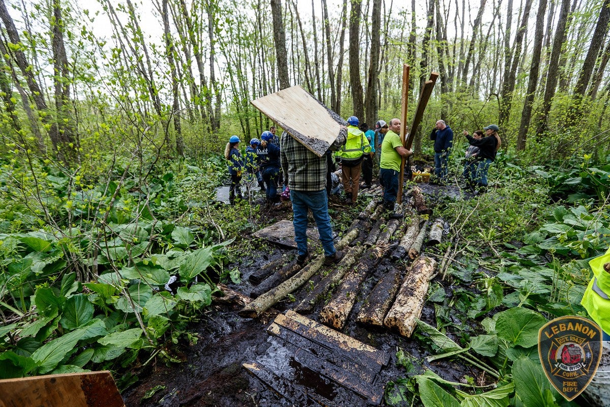 Plywood, logs, cribbing and sings were all used to create a makeshift bridge through the mud