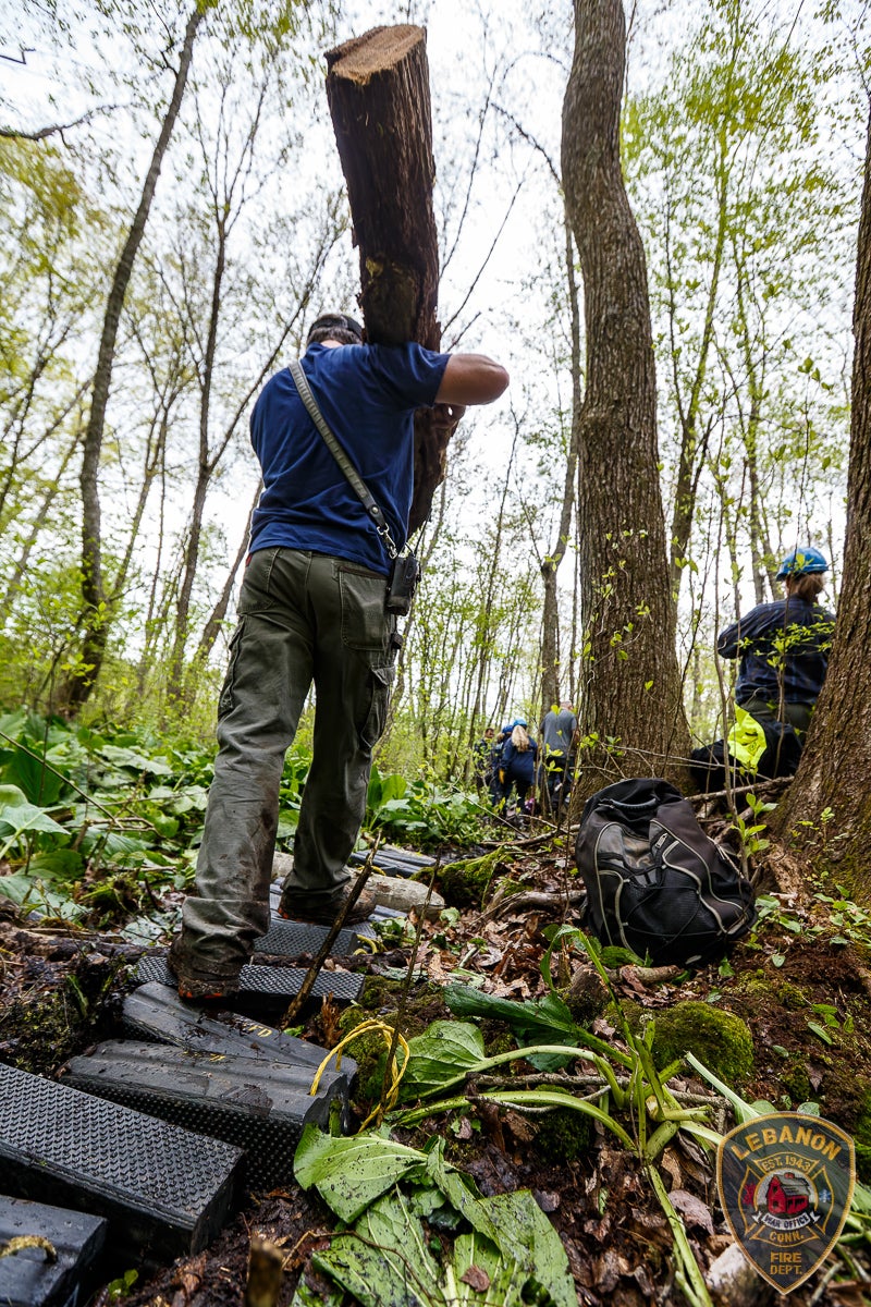 Rescue personnel used logs and other equipment to make a more stable path through the swampy woods
