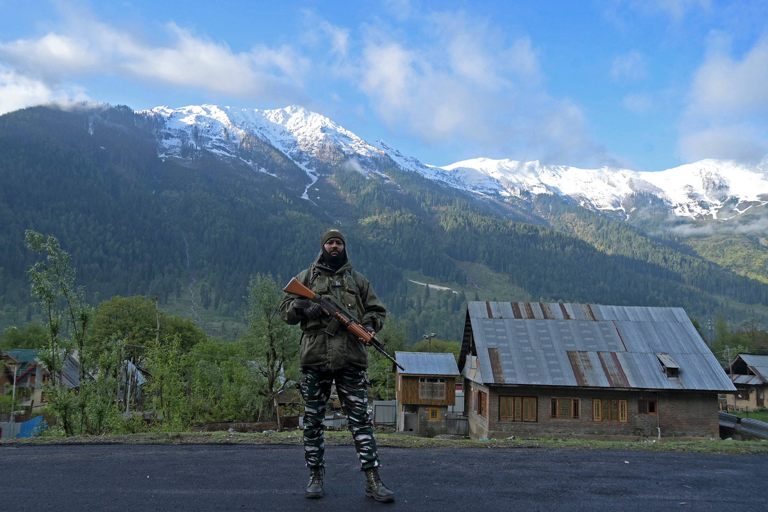 An Indian security personnel stands guard near a polling station during the fourth phase of voting in India’s general election, at Rayil village in Ganderbal district, northeast of Srinagar