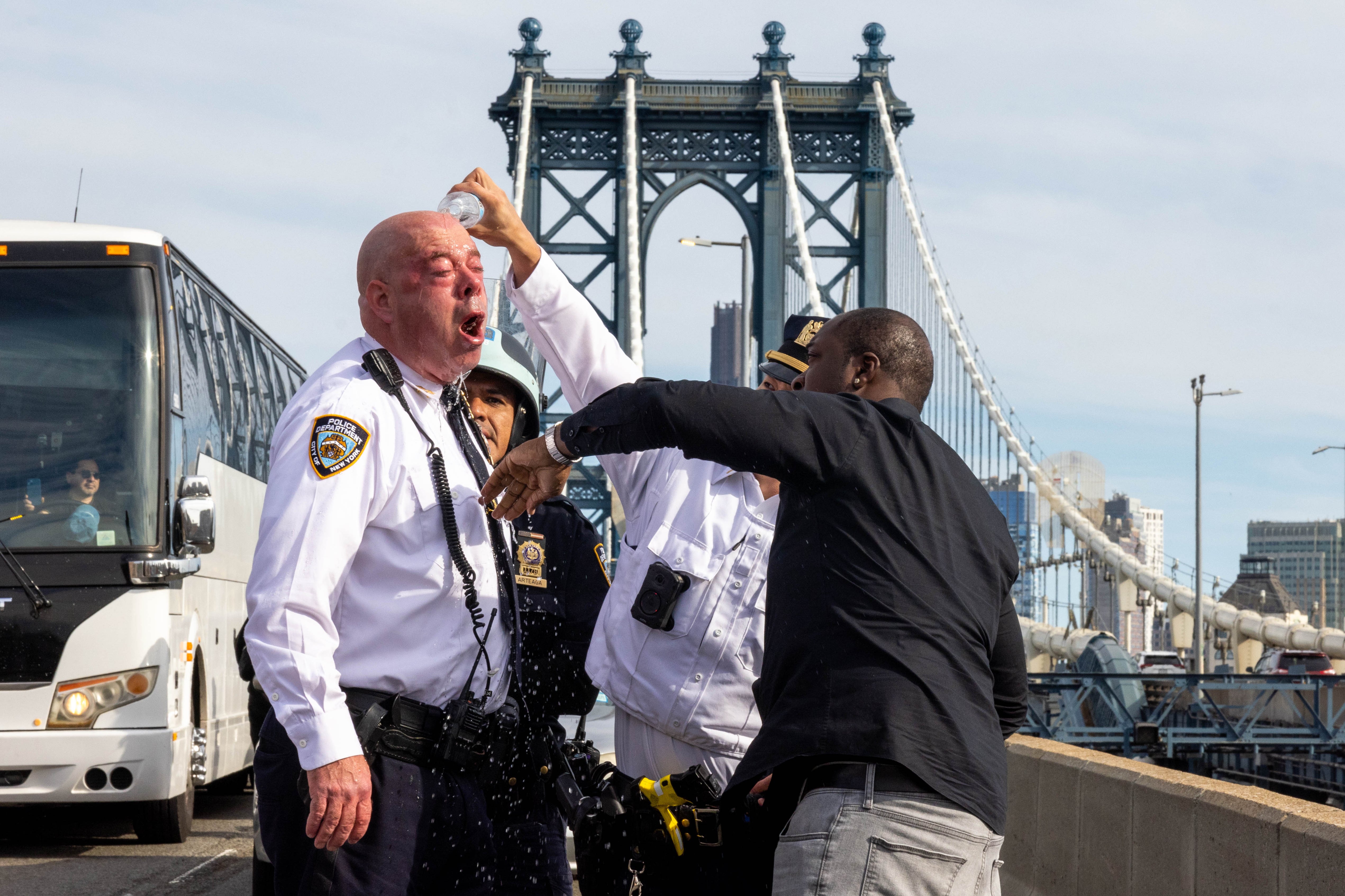 James McCarthy, NYPD assistant chief, is assisted after seemingly being affected by a chemical irritant as police arrest pro-Palestinian demonstrators blocking traffic on the Manhattan Bridge