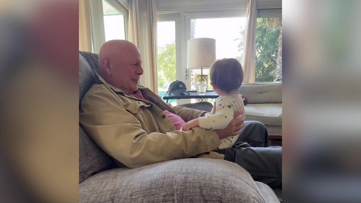 Bruce Willis cuddles with his grandchild in a video shared earlier this year