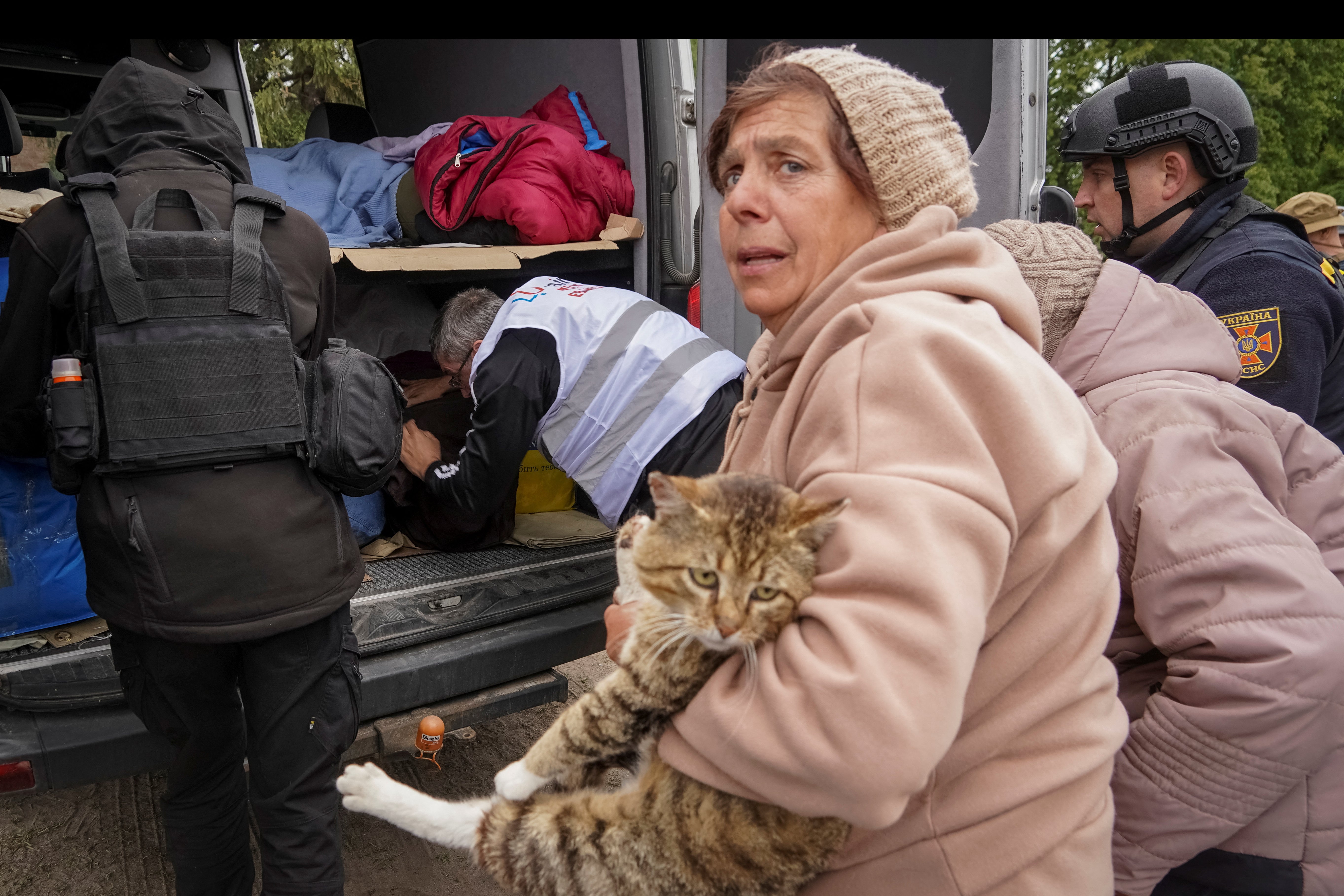 A Ukrainian woman flees with her cat during the Russian advance on Kharkiv