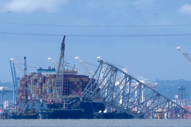 <p>The collapsed Francis Scott Key Bridge rests on the container ship Dali, Sunday, May 12, 2024, in Baltimore</p>