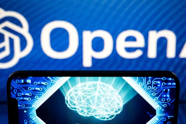 <p>The OpenAI logo shown  above a smartphone screen on 23 January, 2023 in Toulouse, France</p>