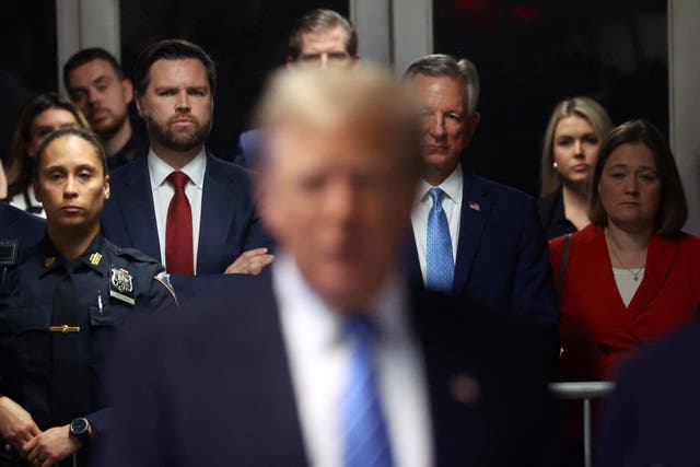 <p>Senators JD Vance (left) and Tommy Tuberville (right) stand behind Donald Trump (center) on 13 May 2024 at the Manhattan Criminal Court. The two senators are rumoured to be candidates for Mr Trump’s running mate</p>