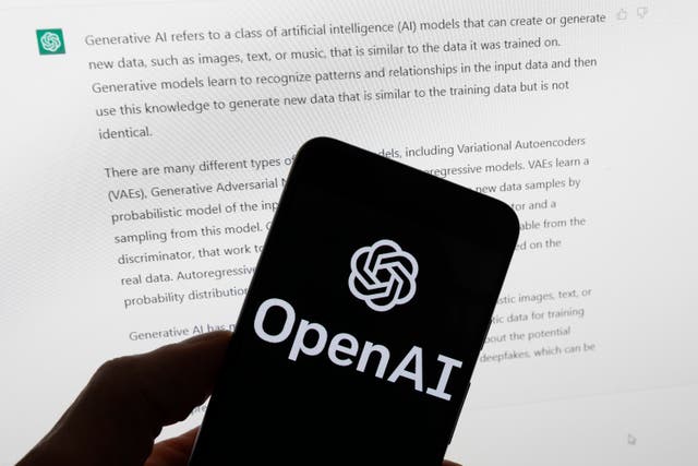 <p>A phone screen displays the logo of OpenAI </p>