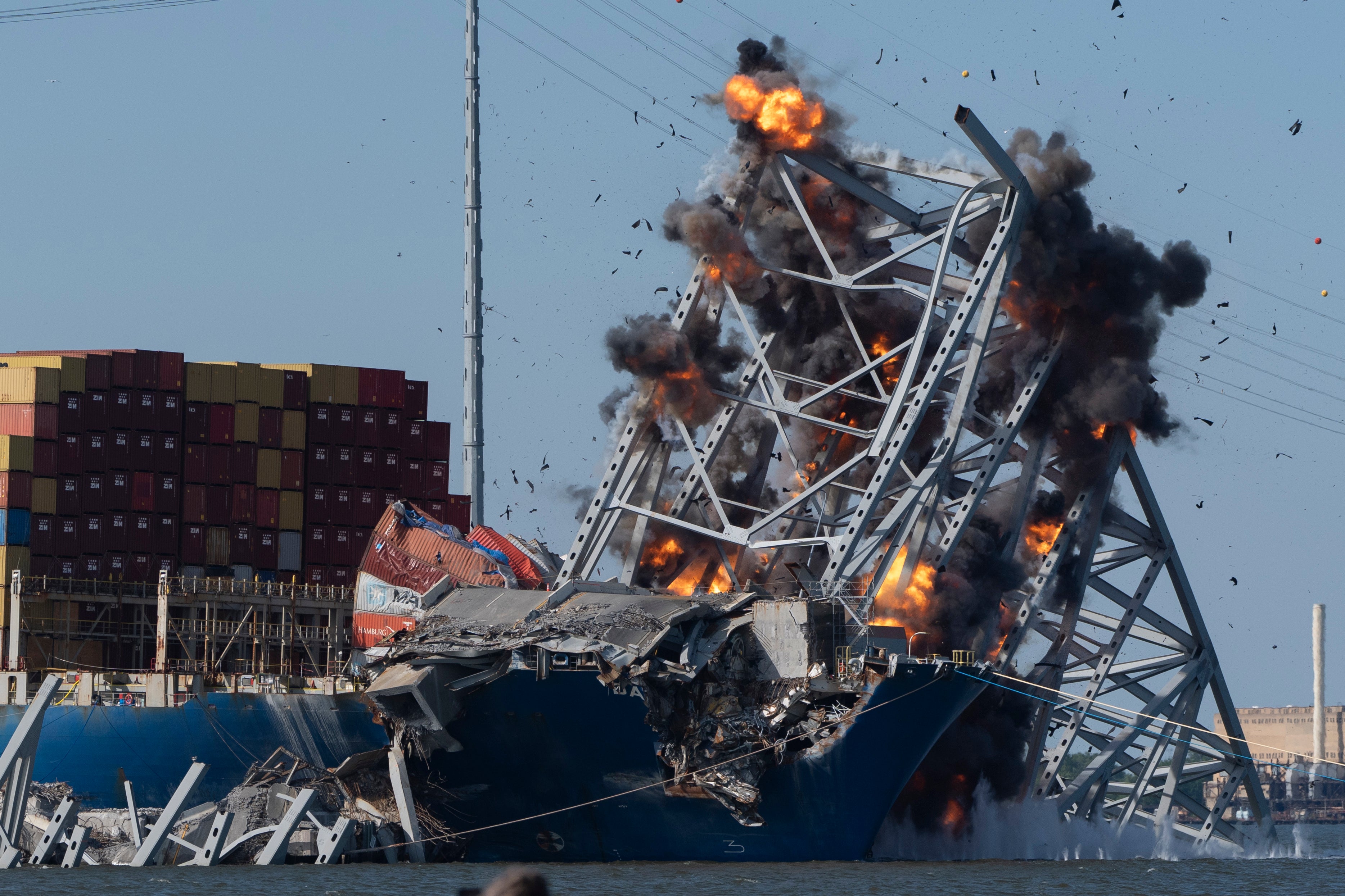 Explosive charges are detonated to bring down sections of the collapsed Francis Scott Key Bridge resting on the container ship Dali on Monday, May 13, 2024, in Baltimore