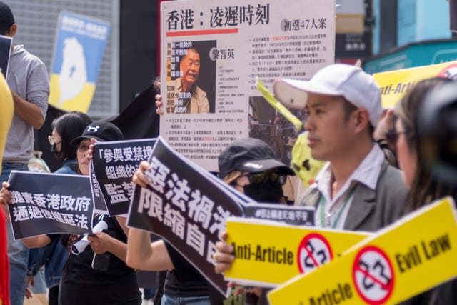 <p>People from Hong Kong living in Taiwan display placards and a poster showing Jimmy Lai during a protest in Taipei</p>