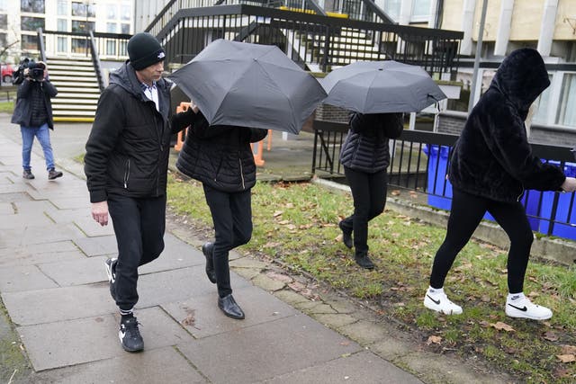 <p>Elliot Benham, 23, (second left under umbrella) and Sophie Harvey, 23, (second right under umbrella) leave Cheltenham Magistrates' Court at an earlier hearing </p>
