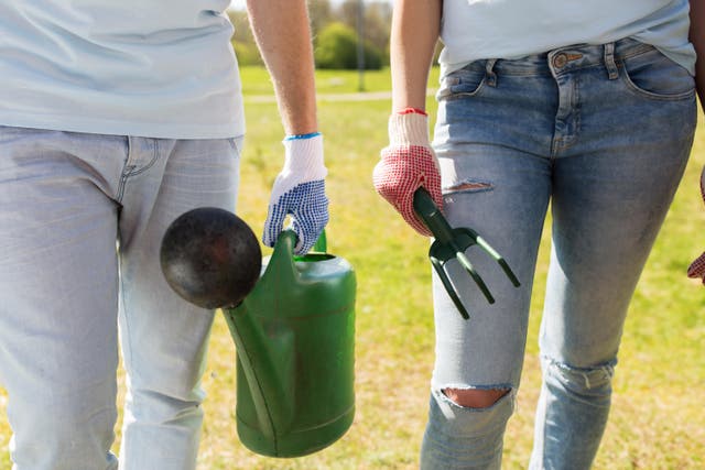 <p>Two gardeners with a watering can and a hand fork: Check out garden summer diary for the job you need to do</p>