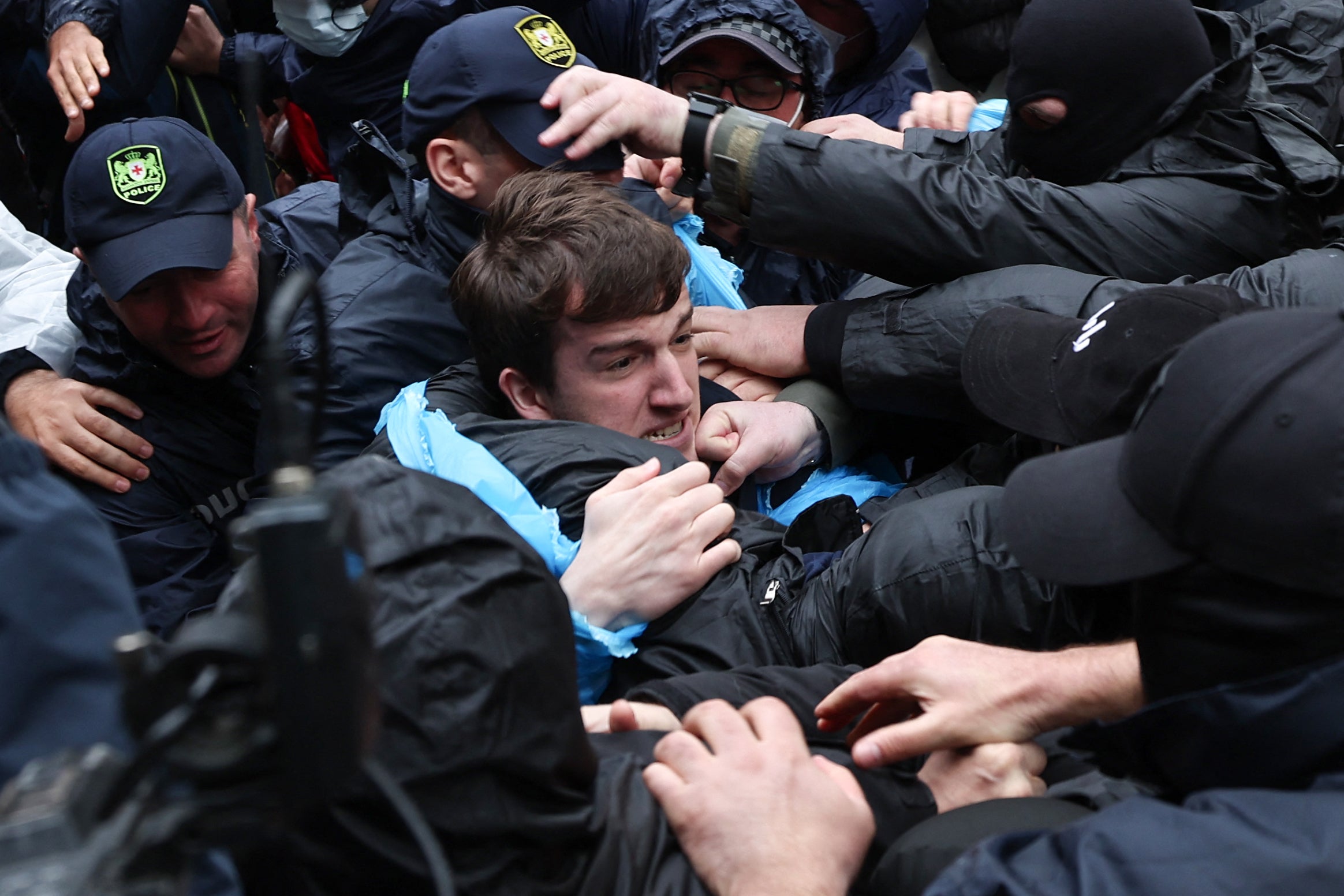 Georgian law enforcement officers detain a demonstrator protesting the controversial ‘foreign influence’ bill