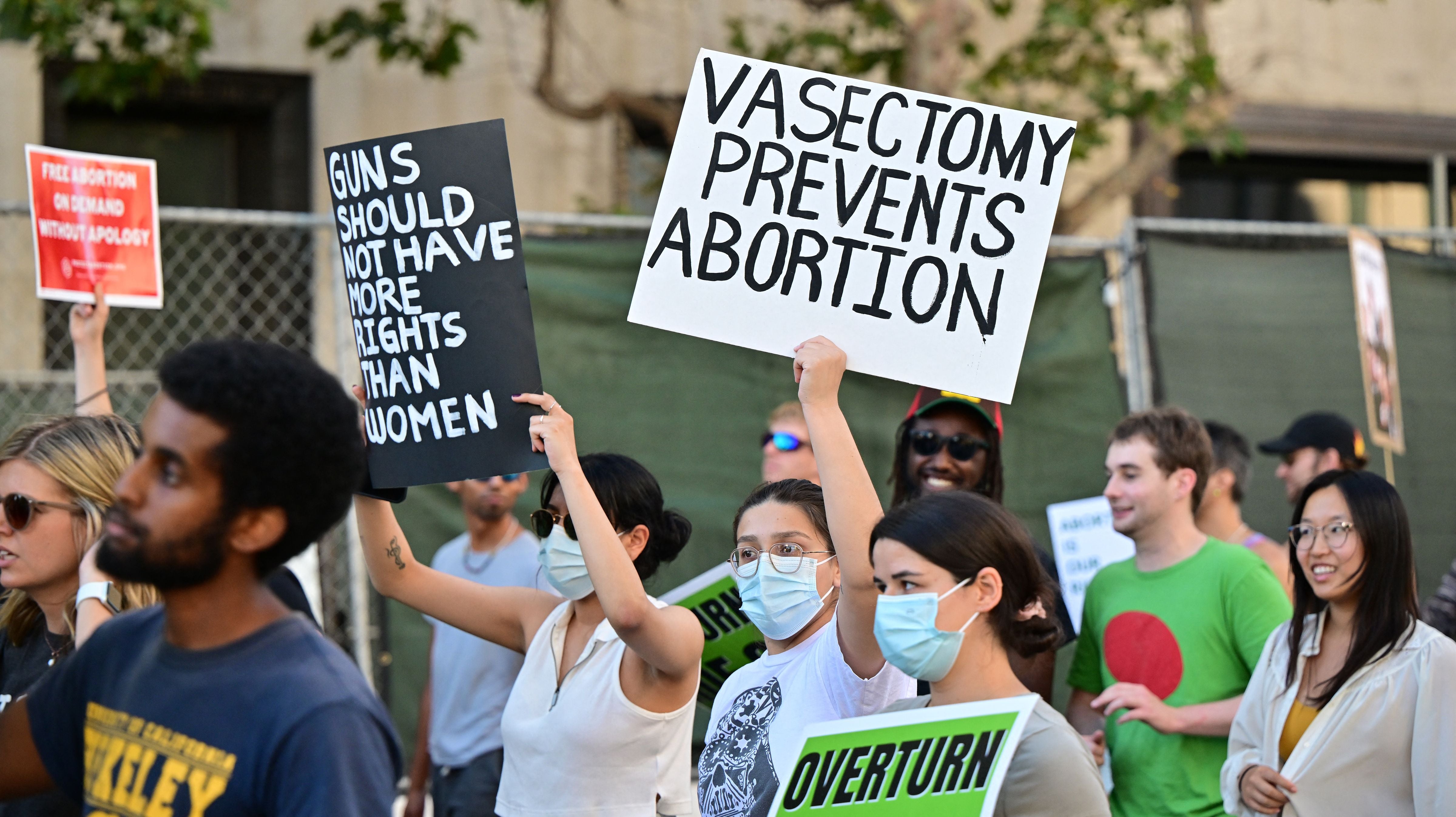 Abortion rights activists hold a sign reading "Vasectomy Prevents Abortion" as they protest after the overturning of Roe Vs. Wade by the US Supreme Court, in Downtown Los Angeles, on June 24, 2022
