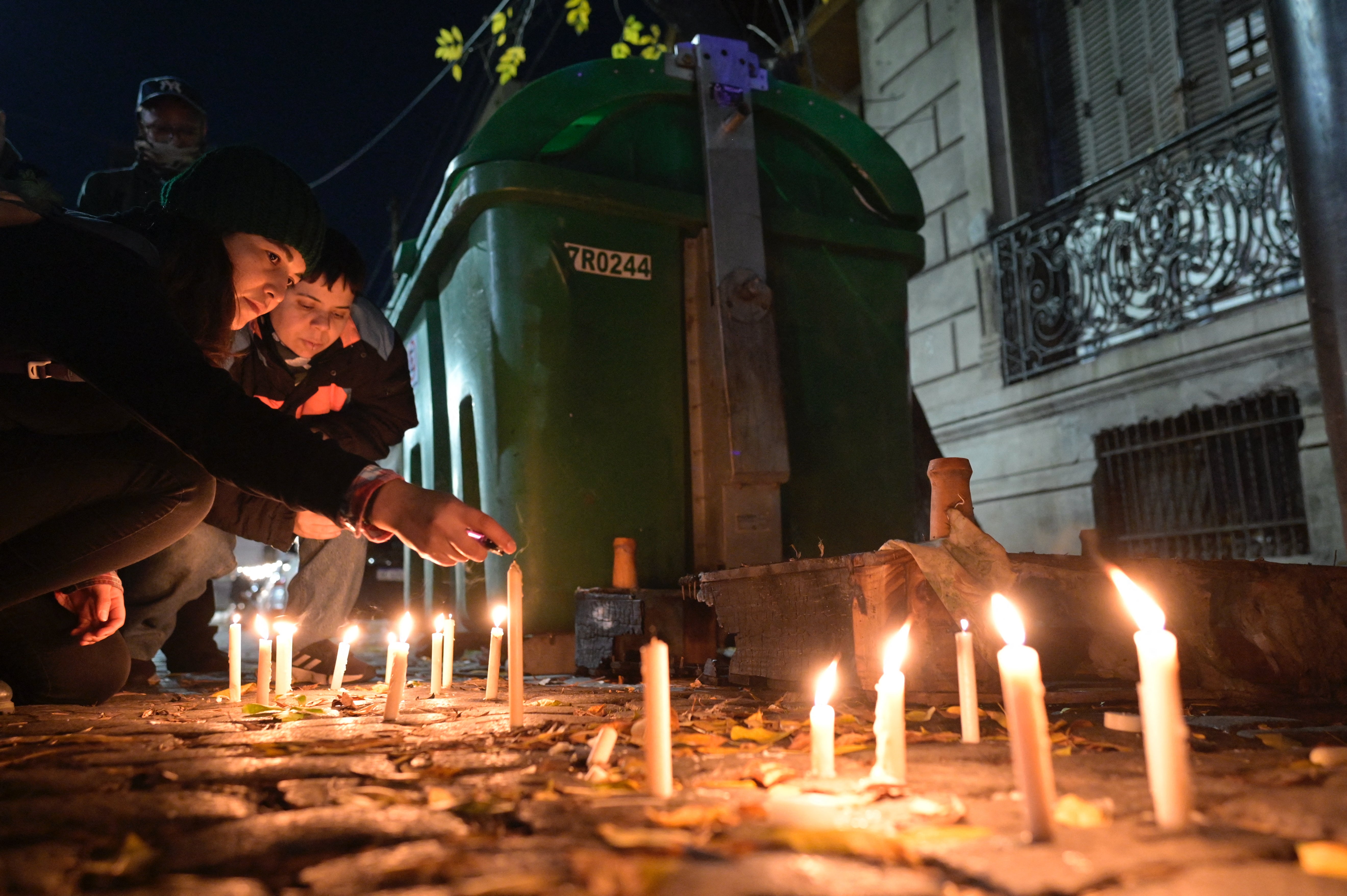 A candlelit vigil outside a house where three women were killed in an arson attack