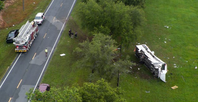 <p>Emergency services attend the scene after a bus carrying laborers to a melon farm overturned in a fatal crash near Dunnellon, Florida on May 14, 2024</p>