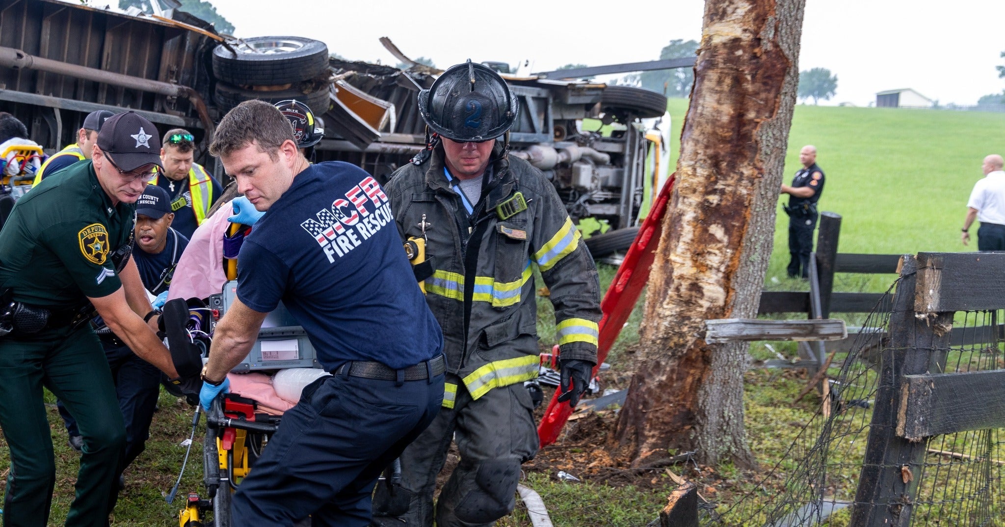 EMS workers are seen transporting one of the dozens injured in a fatal bus crash in Marion County, Florida, on Tuesday 14 May 2024