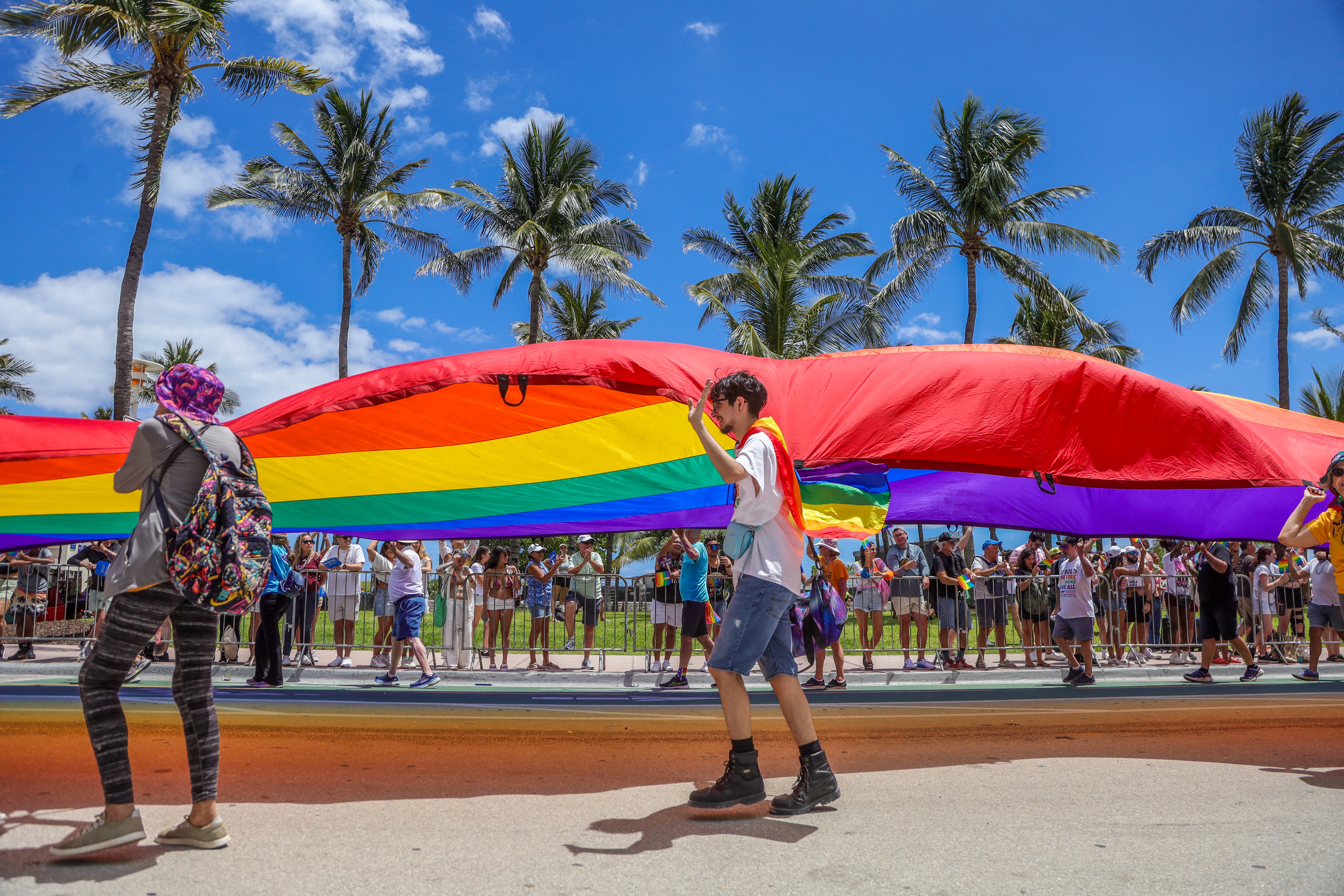 Revelers take part in the Miami Beach Pride Parade on Ocean Drive on April 14, 2024, in Miami Beach, Florida