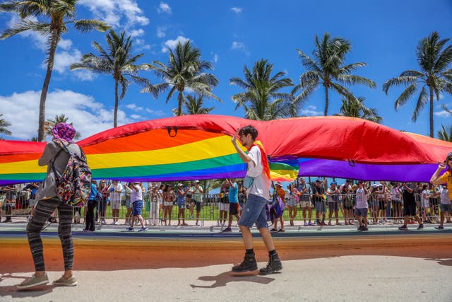 <p>Revelers take part in the Miami Beach Pride Parade on Ocean Drive on April 14, 2024, in Miami Beach, Florida</p>