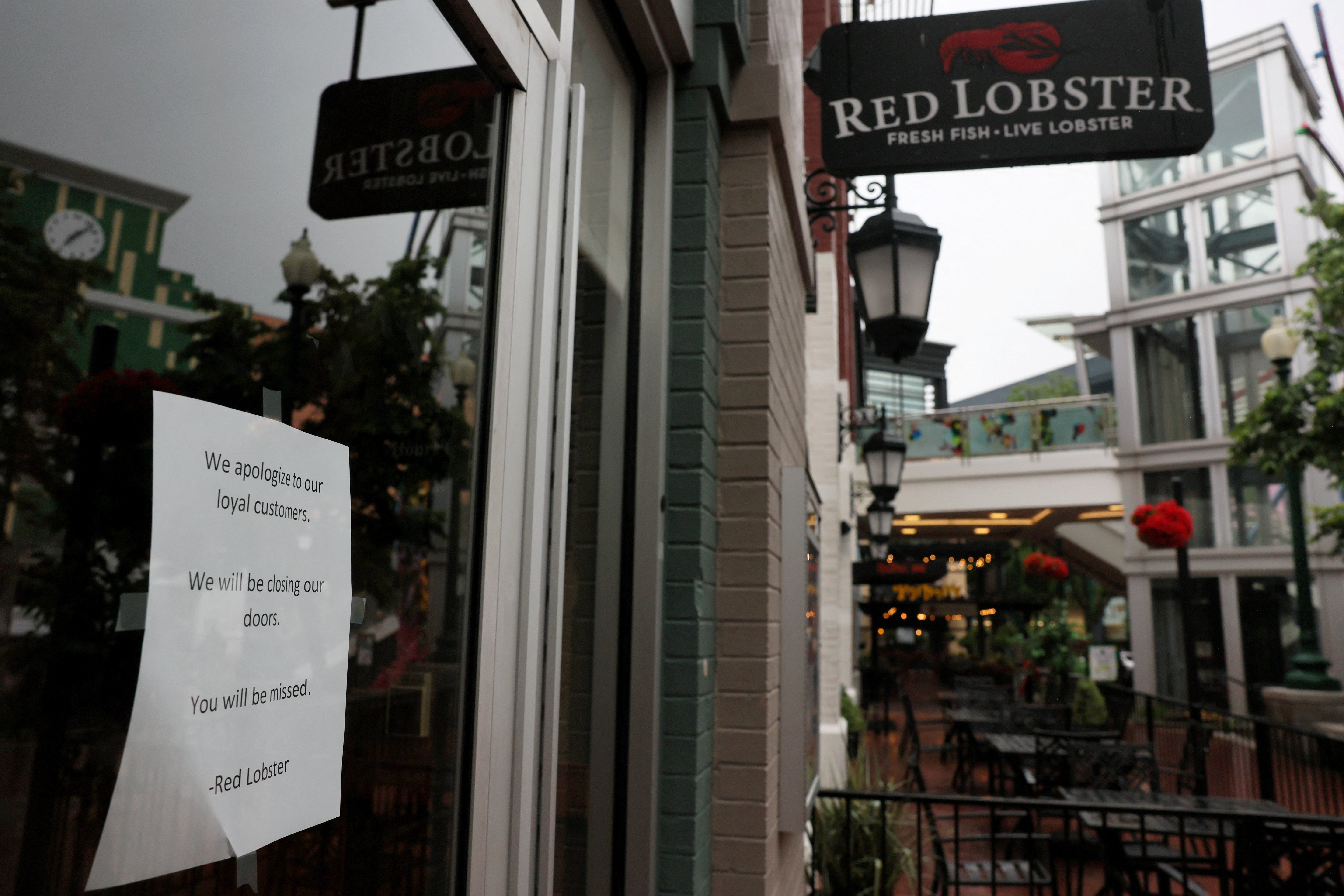 A sign taped to a door announces the closure of a Red Lobster in Silver Spring, Maryland, on 14 May 2024