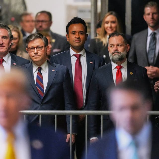 <p>US Rep Byron Donalds, Doug Burgum, House Speaker Mike Johnson, Vivek Ramaswamy and US Rep Cory Mills watch Donald Trump speak in a Manhattan criminal court hallway on 14 May</p>