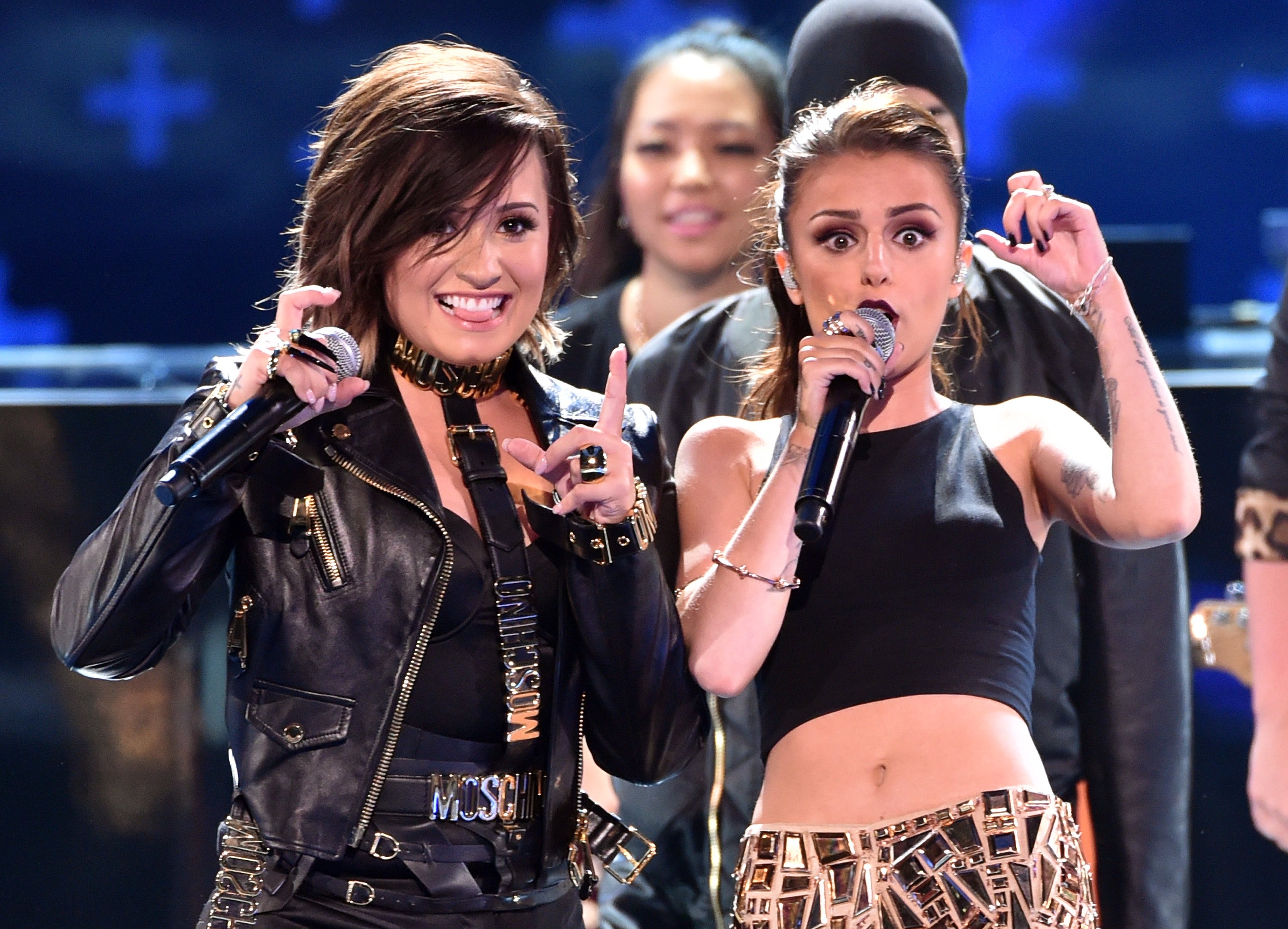 Recording artists Demi Lovato (L) and Cher Lloyd perform onstage during FOX's 2014 Teen Choice Awards