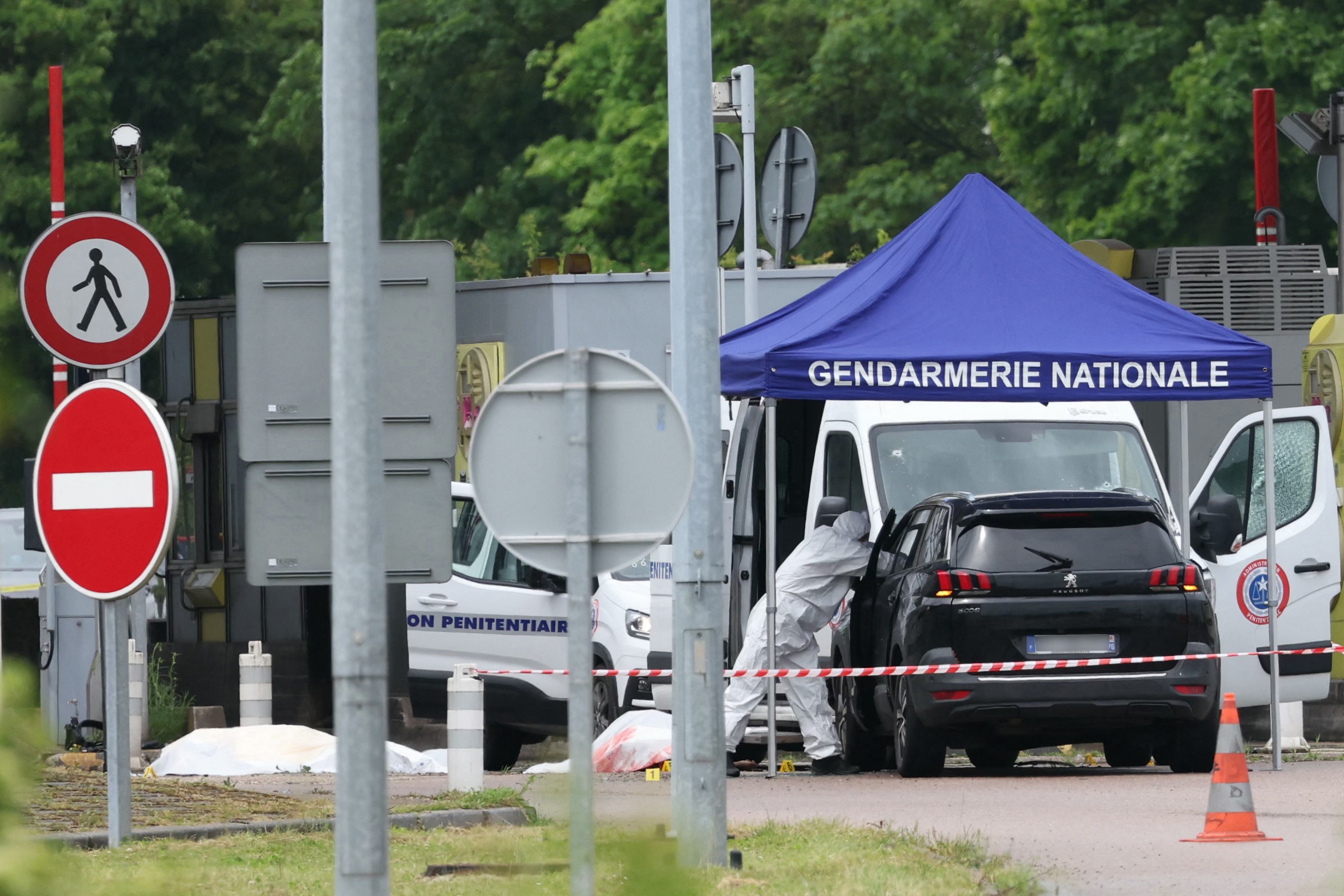 Forensic teams at the scene of the ambush that took place at Incarville tollbooth on Tuesday morning