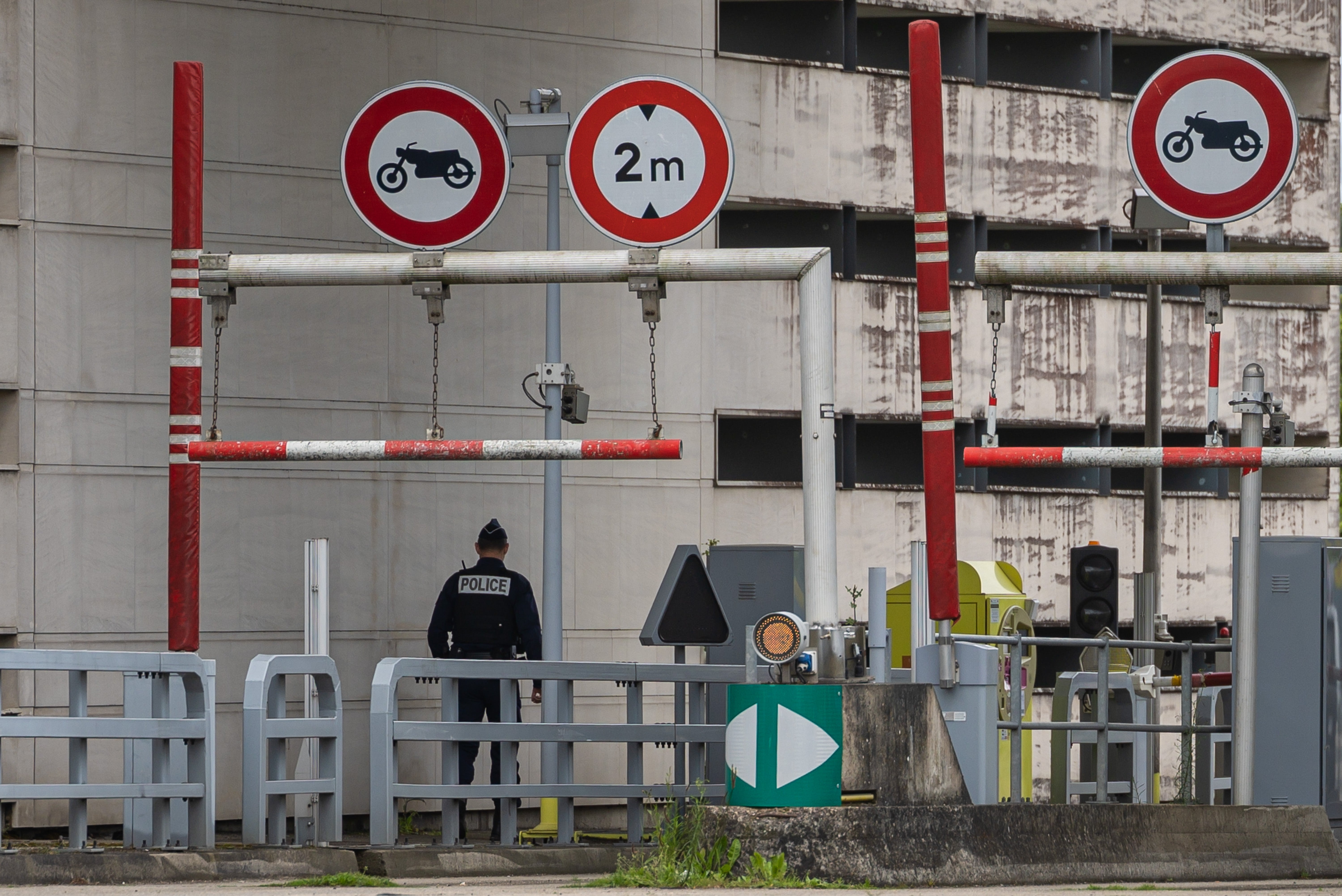 Police officers stand guard at the tollbooth which remains closed after Tuesday morning’s ambush