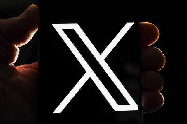 <p>The X logo on a smartphone on 24 July, 2023 in London, England</p>