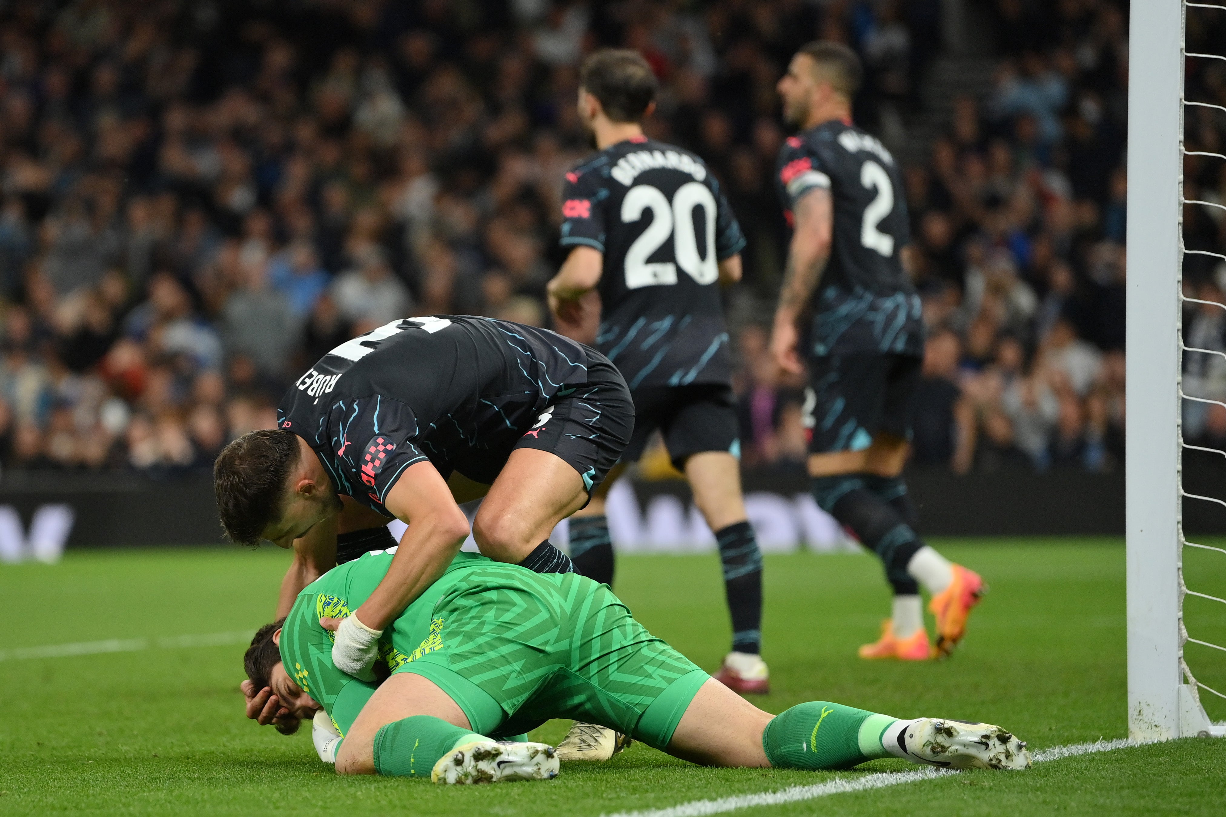 Manchester City’s Ruben Dias embraces goalkeeper Stefan Ortega