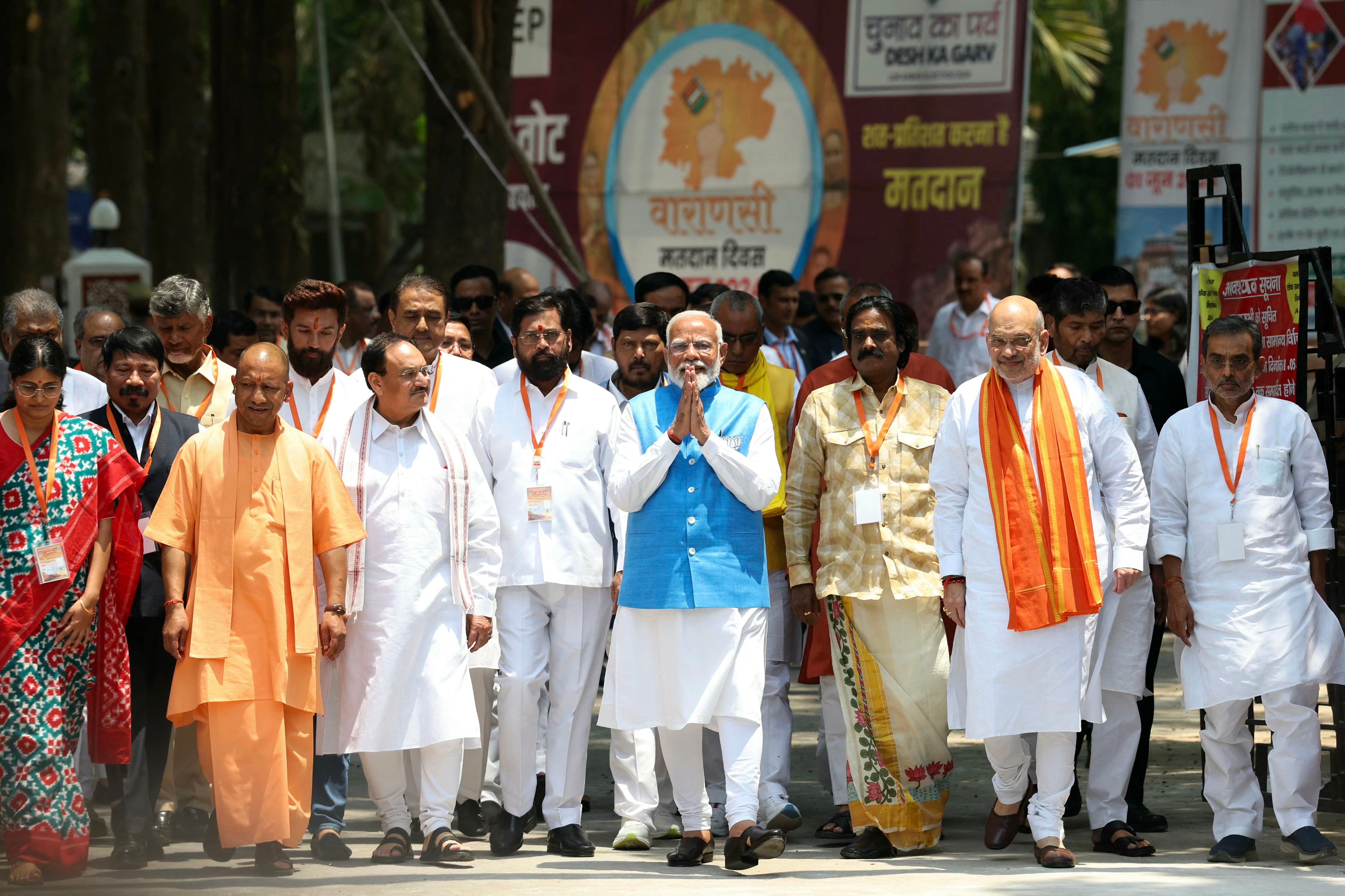 India’s prime minister Narendra Modi (C), surrounded by other party leaders and MPs including home minister Amit Shah and Uttar Pradesh chief minister Yogi Adityanath, greets supporters after filing nomination papers on 14 May 2024 in Varanasi