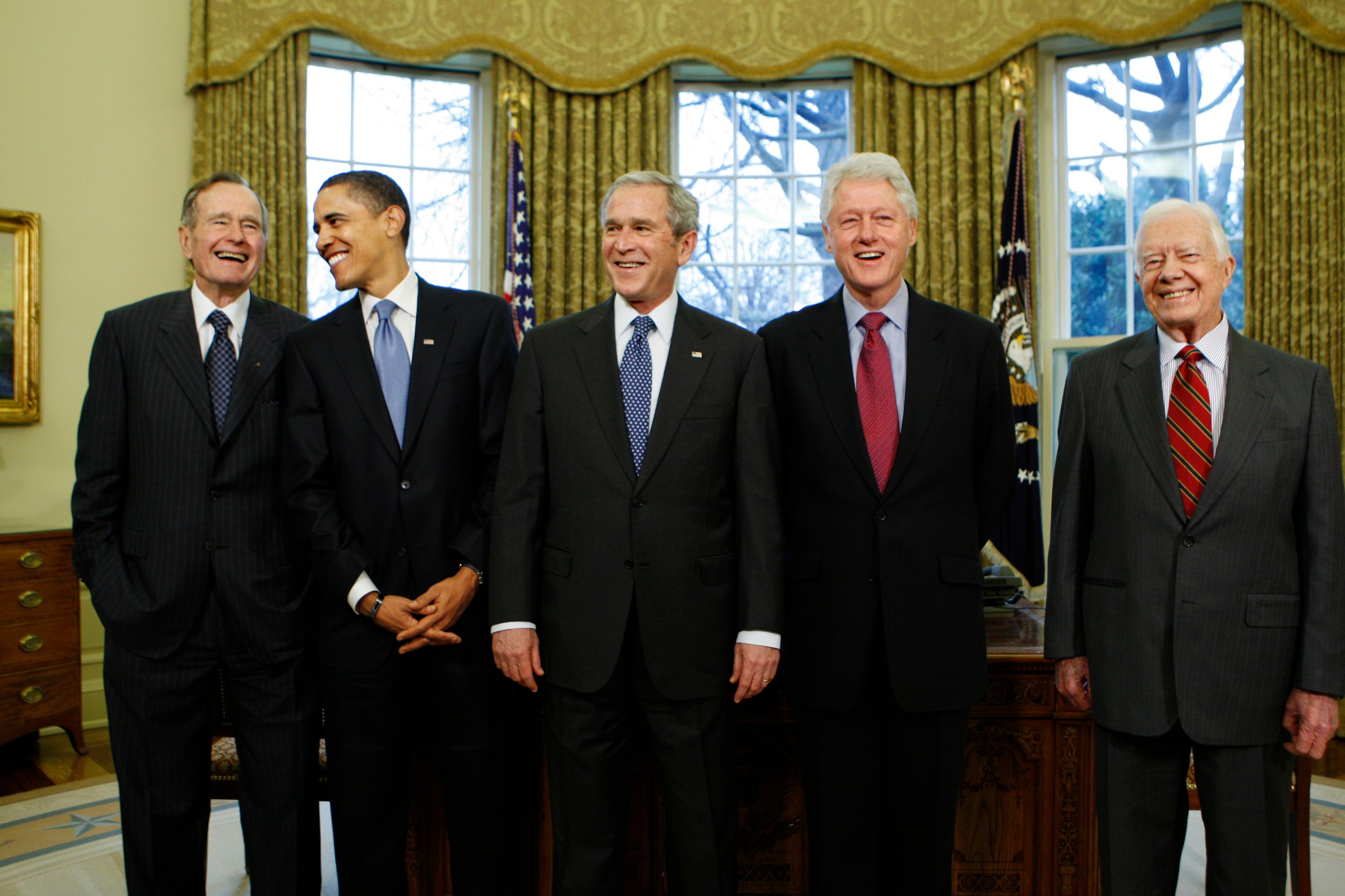 President George W. Bush (center) welcomes president-elect Barack Obama (second left) at the White House in January 2009, with George H.W. Bush, Bill Clinton and Jimmy Carter (left to right). Bush has stayed out of the presidential election this year