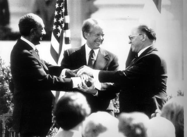 <p>President Jimmy Carter with President Menachem Begin and Anwar Sadat after the signing of a peace treaty between Israel and Egypt</p>