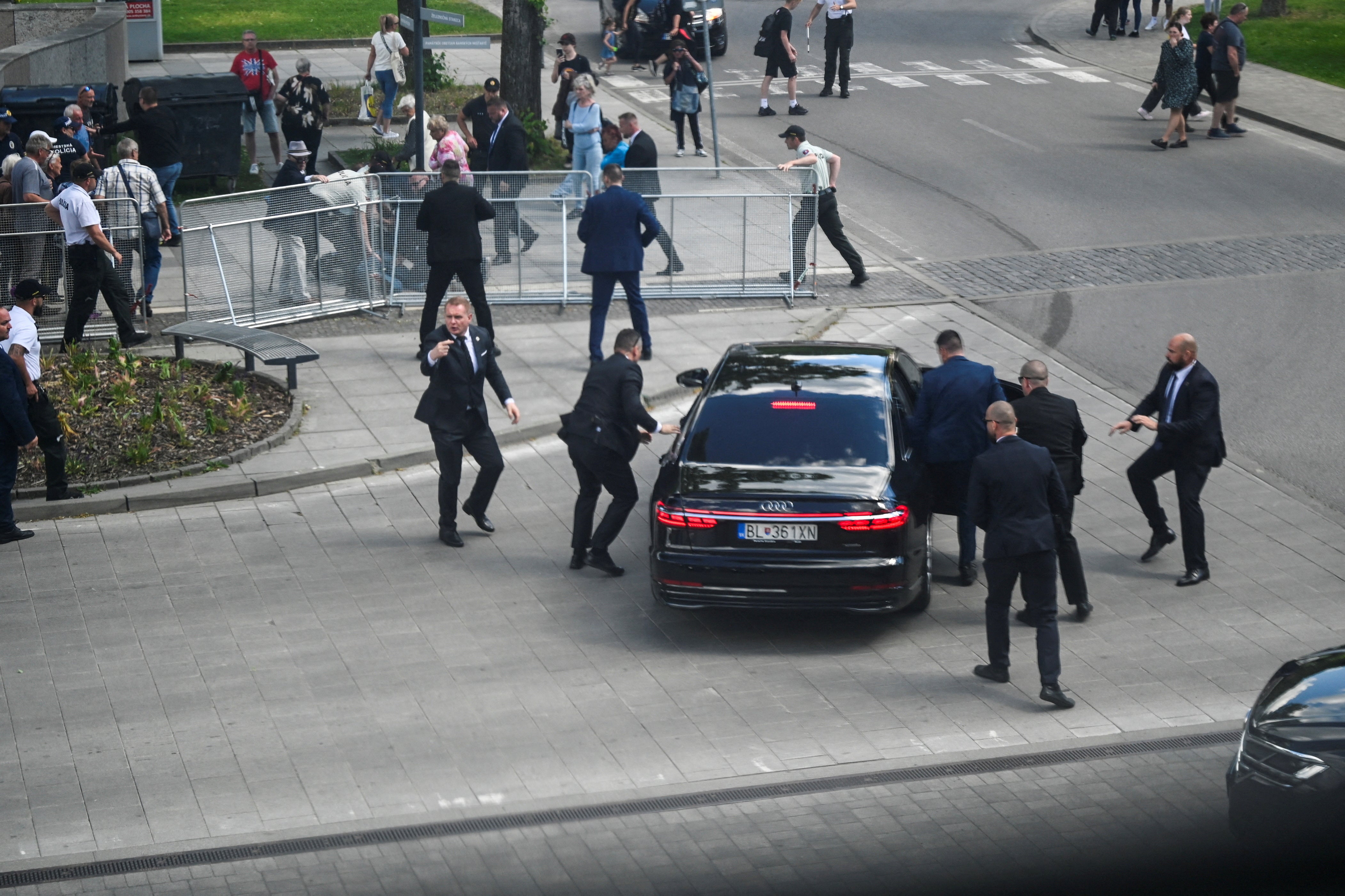 Security officers drag Slovak PM Robert Fico into his official car after the assassination attempt in Handlova