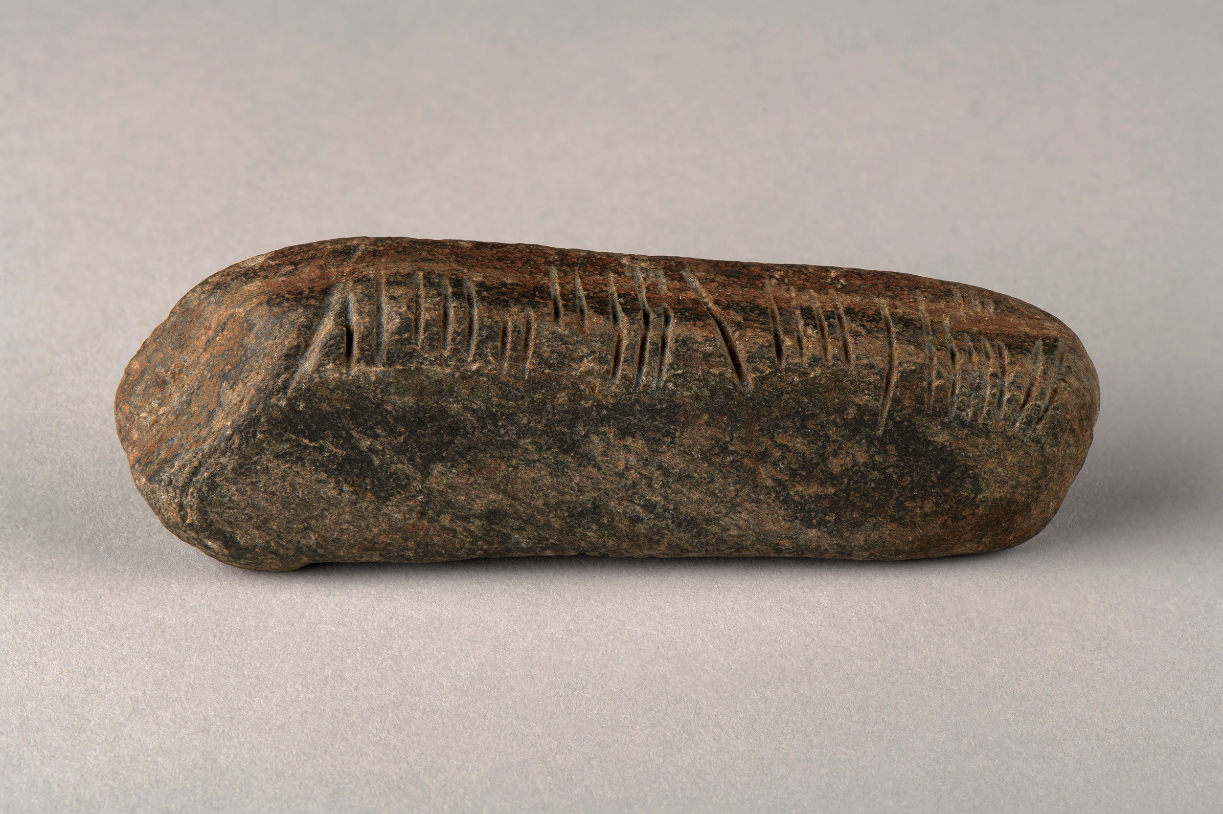 The object is made of sandstone, weighs about 139g and is about 11cm in length