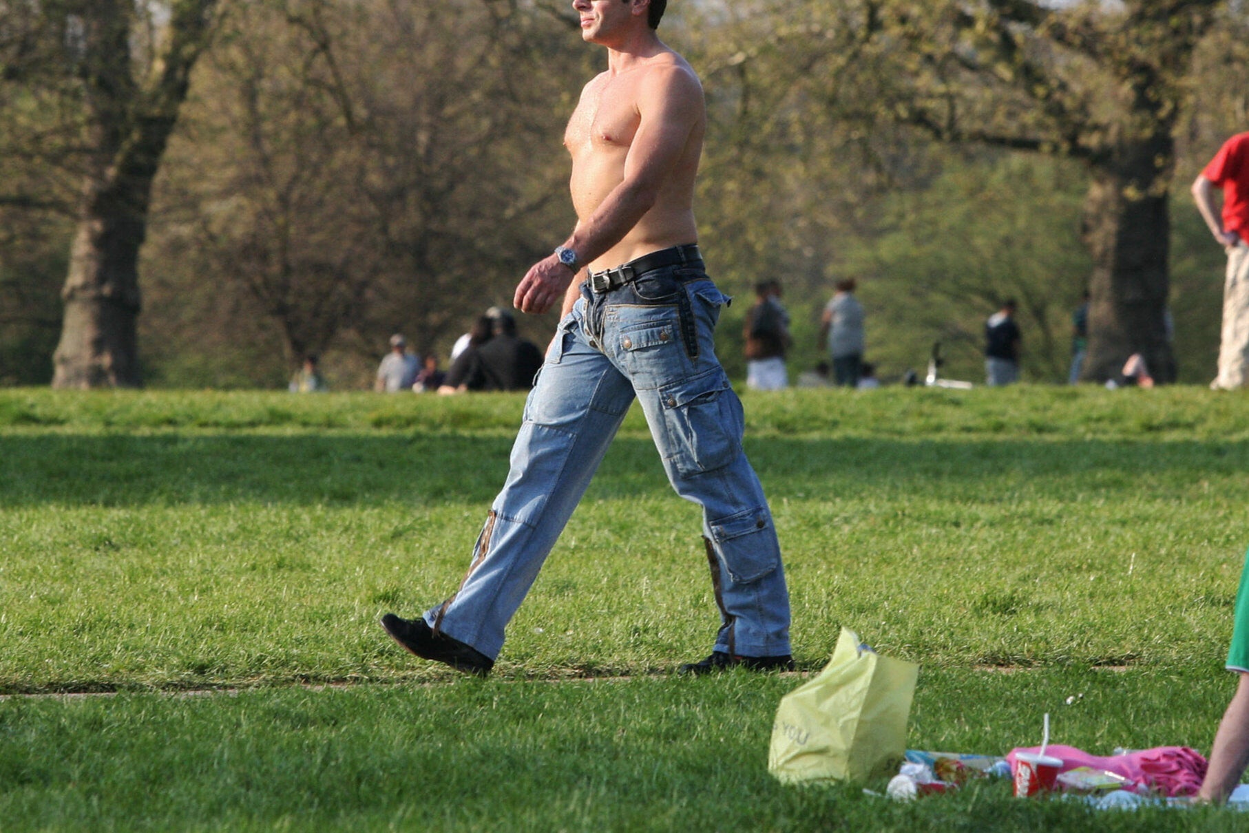 Typical summer sight: a man walks topless through London’s Hyde Park