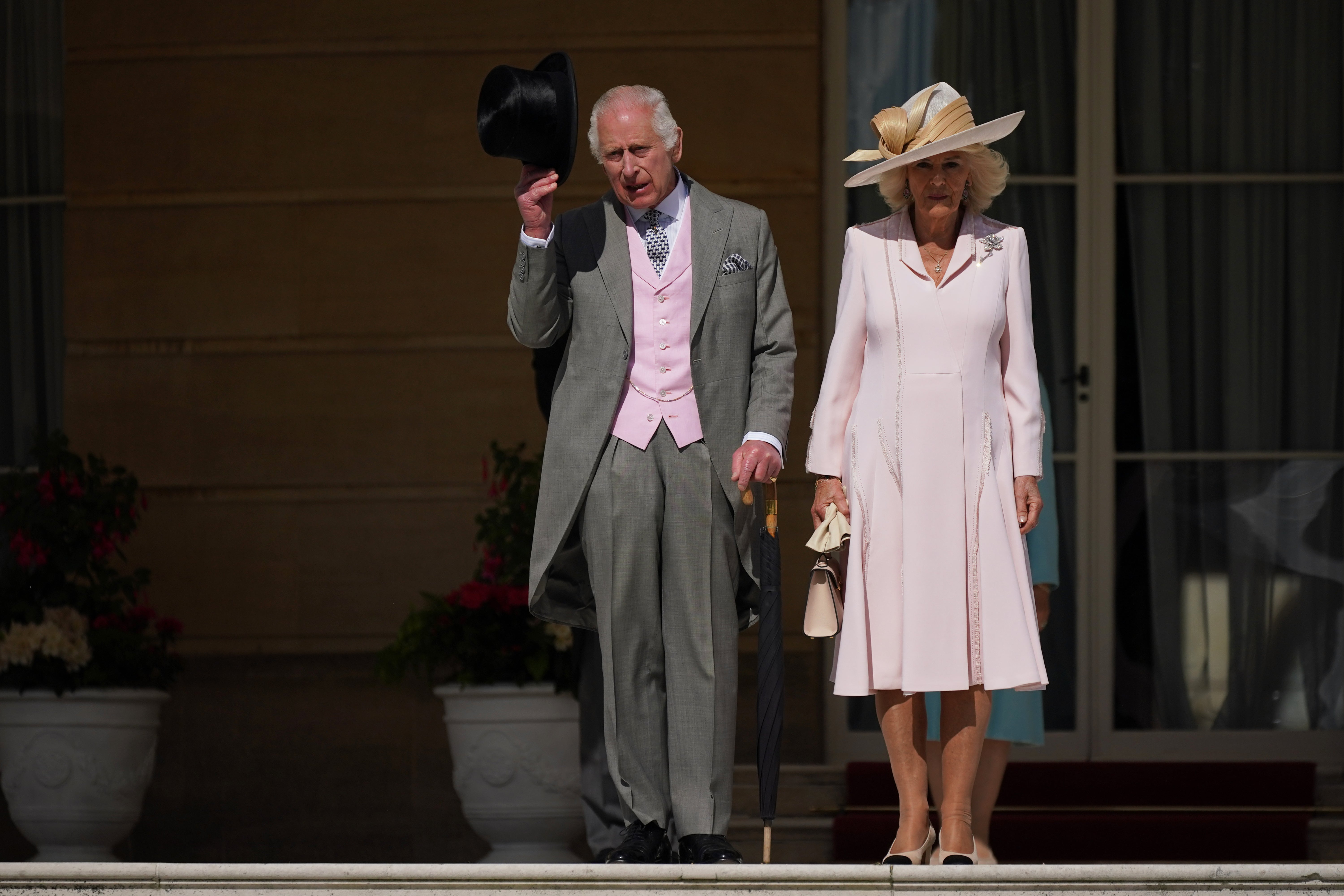 The King and Queen arrive at the garden party with a touch of pink